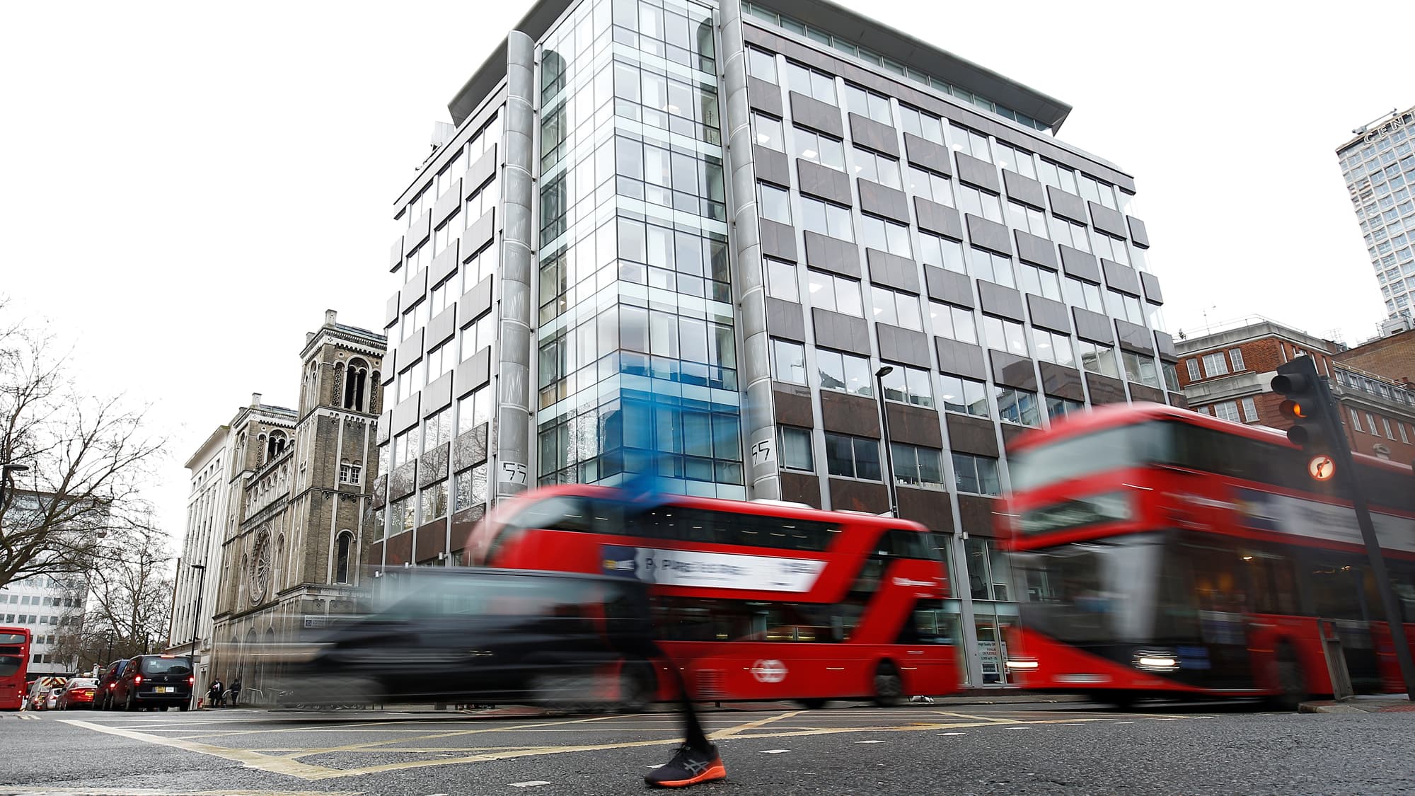 People walk past in a blur the building housing the offices of Cambridge Analytica in central London.