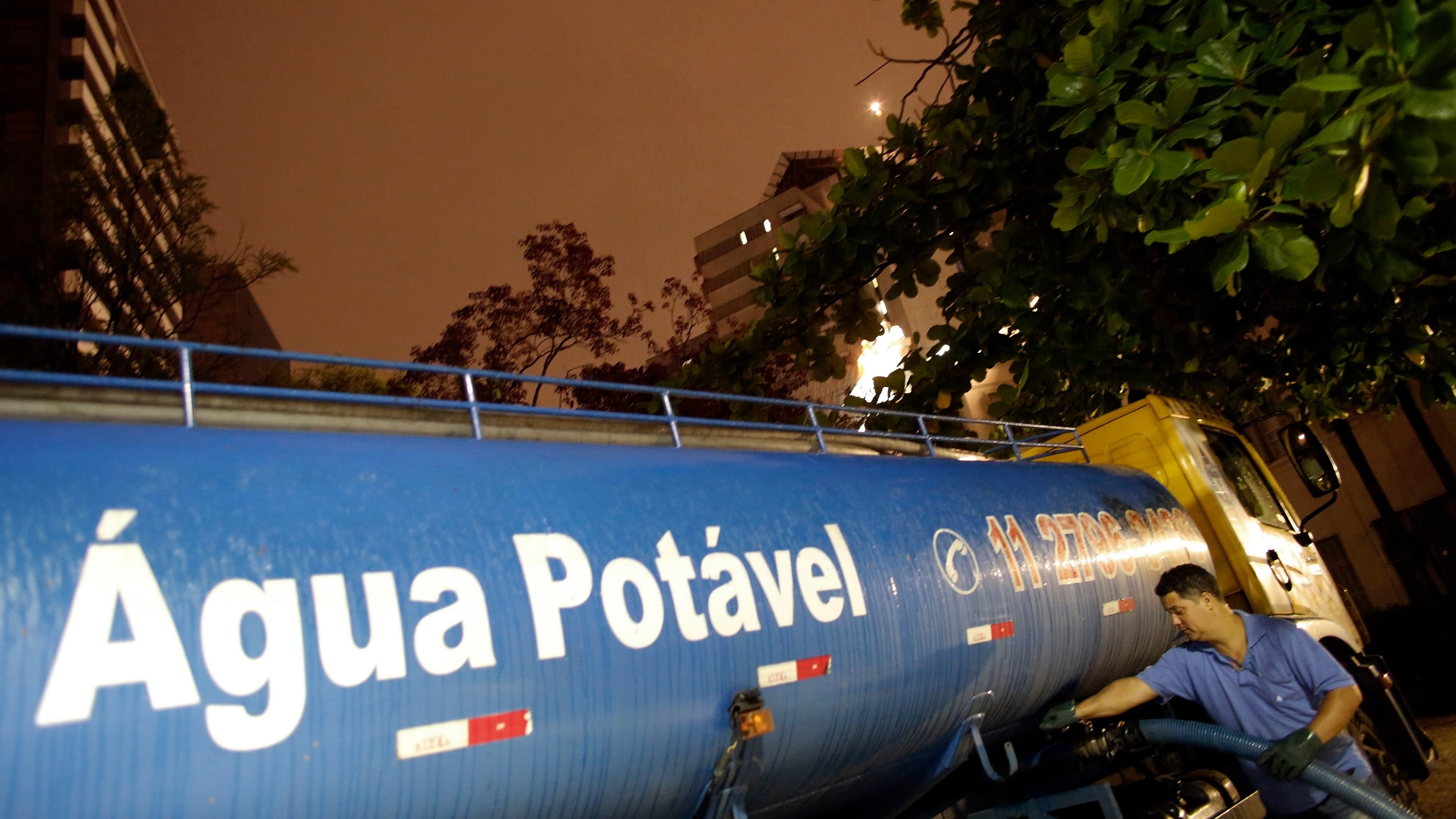 A worker fills a water tanker for distribution to a hospital in São Paulo in February. Residents throughout the metropolitan region of 20 million people are taking emergency measures amid a severe drought.