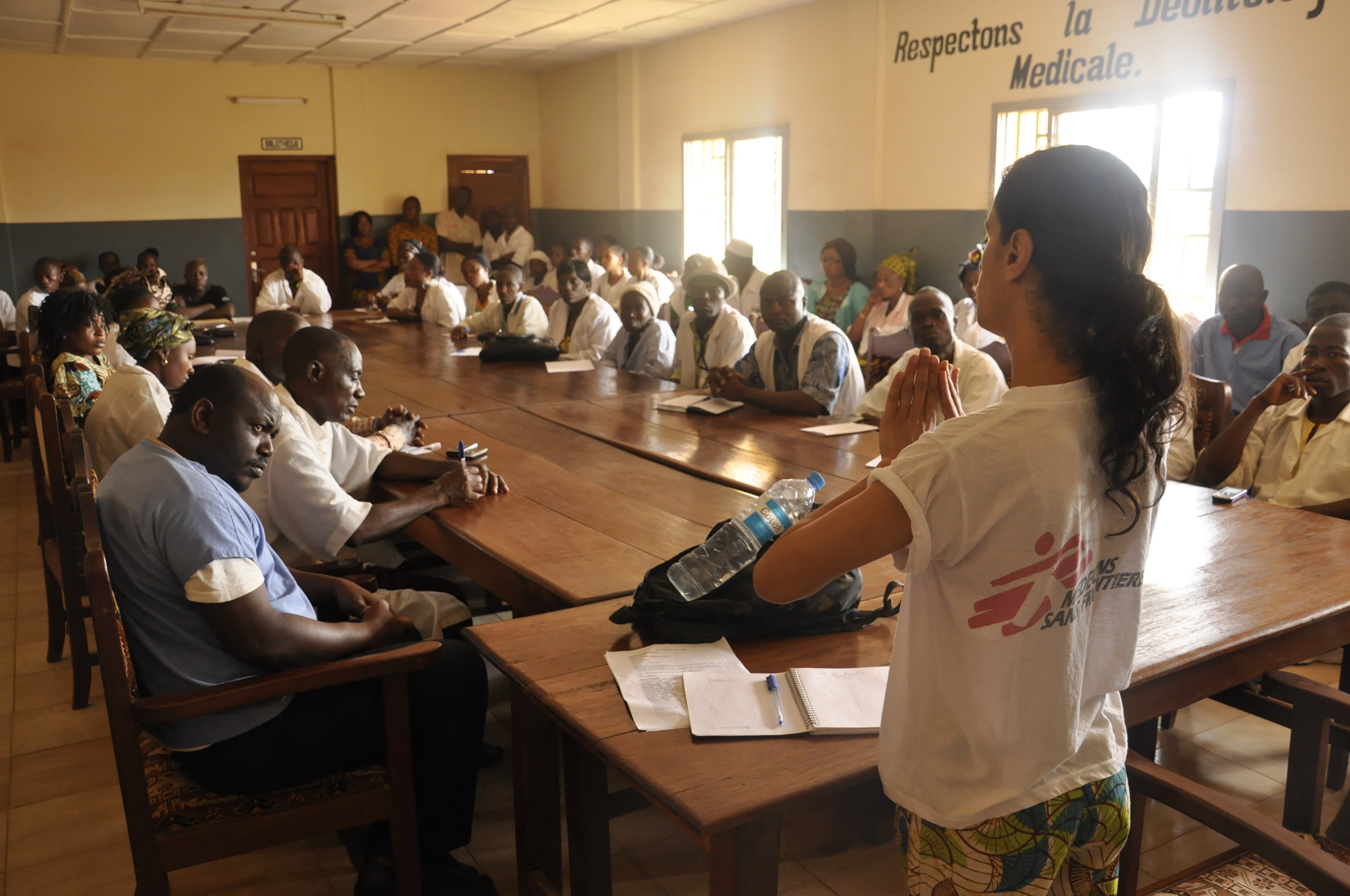 Nurse Monia Sayah of Doctors Without Borders explains to a hospital medical team in Guéckédou, Guinea, how the Ebola virus is transmitted.