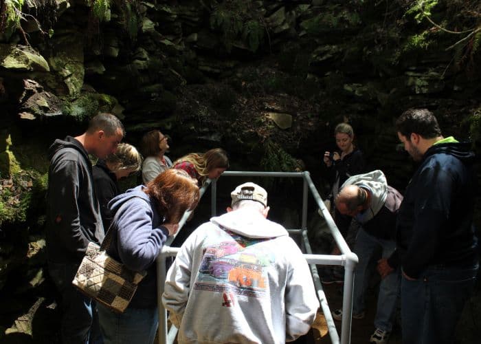 Tourists crowd around the pit in the Coudersport Ice Mine, a Pennsylvania tourist attraction where ice only forms during the summer.