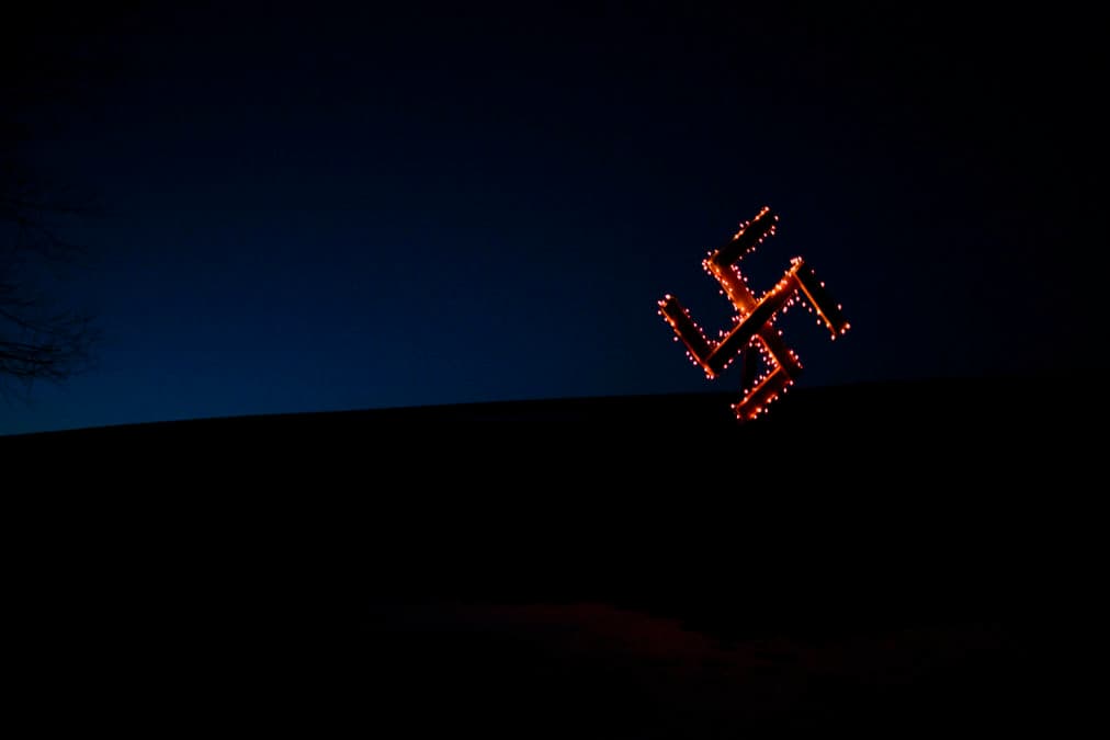 A swastika lights up the night at the Ulysses, Pennsylvania, home of Daniel Burnside, a white supremacist Odinist who is raising his seven children in the religion.