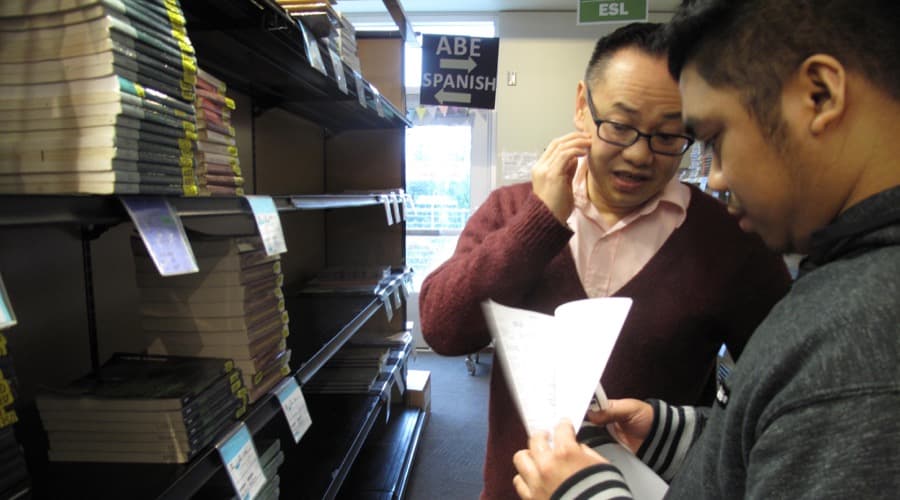 Ekk Sisavatdy, left, helps an incoming freshman at Highline College in Burien, Washington, as part of a program that assists Asian American and Pacific Islander students.