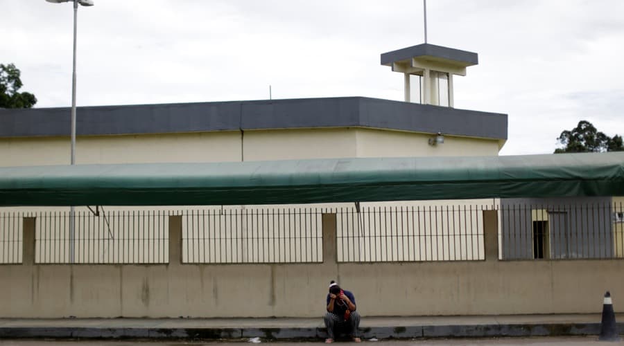 A relative of a prisoner sat on Jan. 3 outside Anisio Jobim prison in Manaus, Brazil