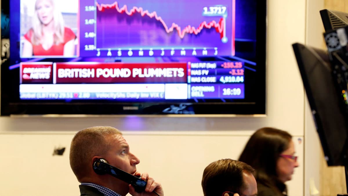 Traders work on the floor of the New York Stock Exchange before the opening bell, June 24, 2016.