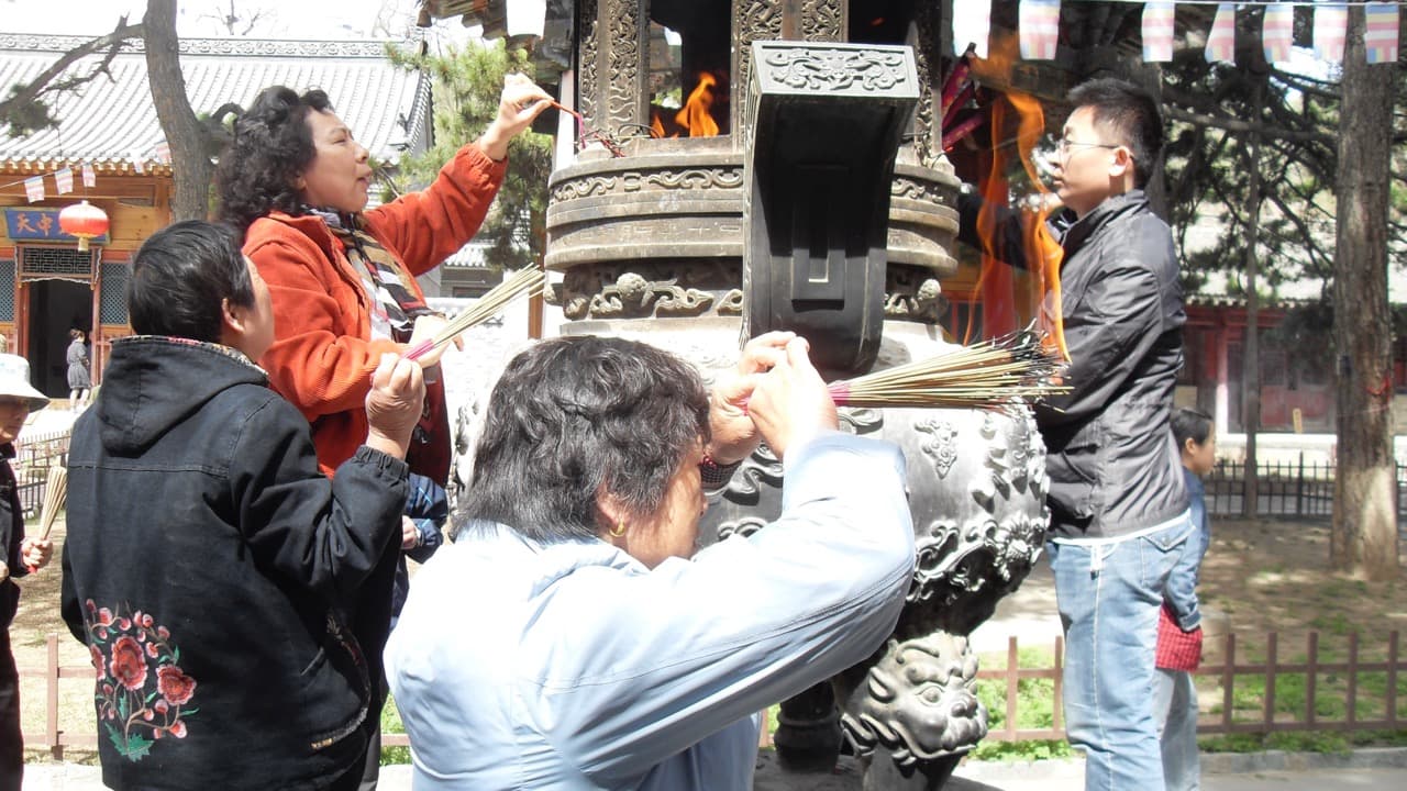 Chinese offer incense at a Buddhist temple in Wutaishan, China