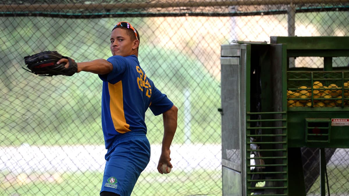 High school student Pedro Otero warms up his arm at the Carlos Beltran Baseball Academy in Puerto Rico.