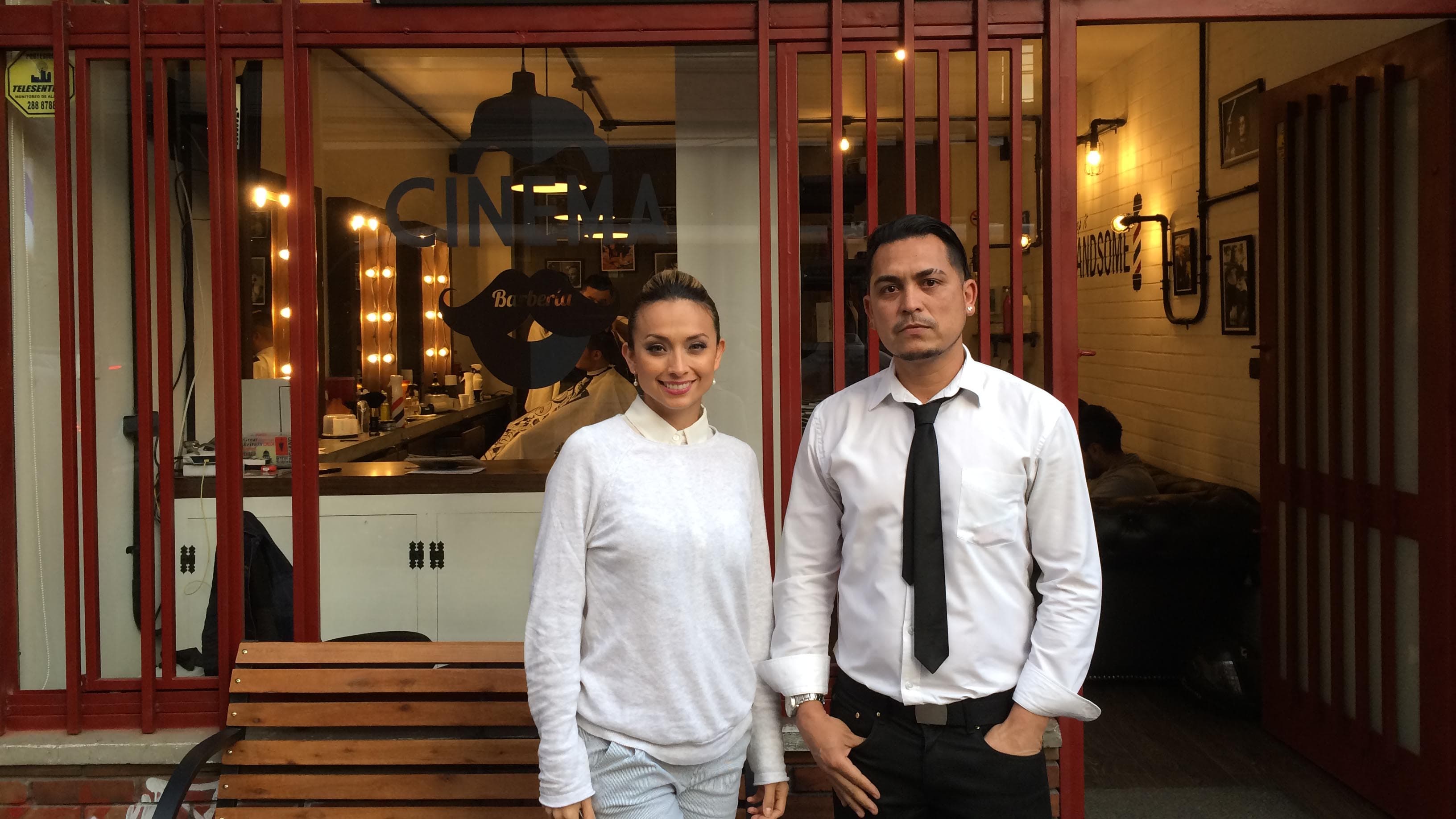 Gustavo Canduri (r) owned a small business back in Venezuela. Now he's working at a barbershop in Bogotá owned by Camila Rincón (l).