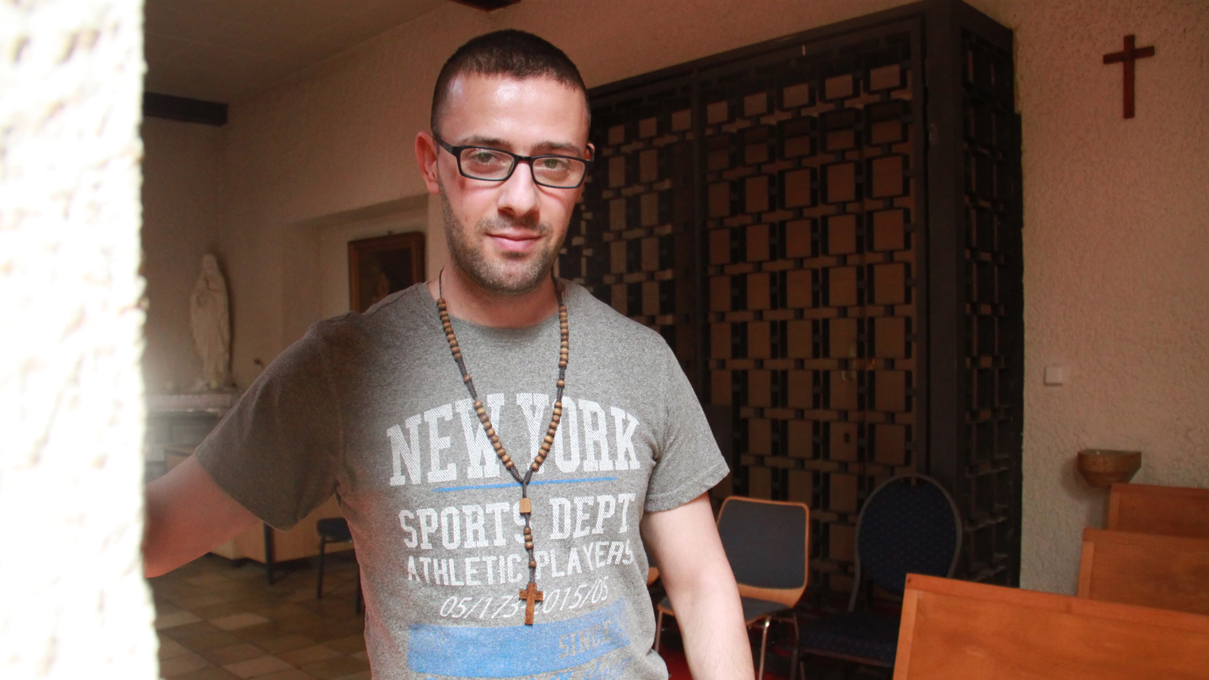 Tarek Bakhous is a Syrian Christian refugee. He says he faced harassment from his Syrian Muslim refugee roommates in Berlin.