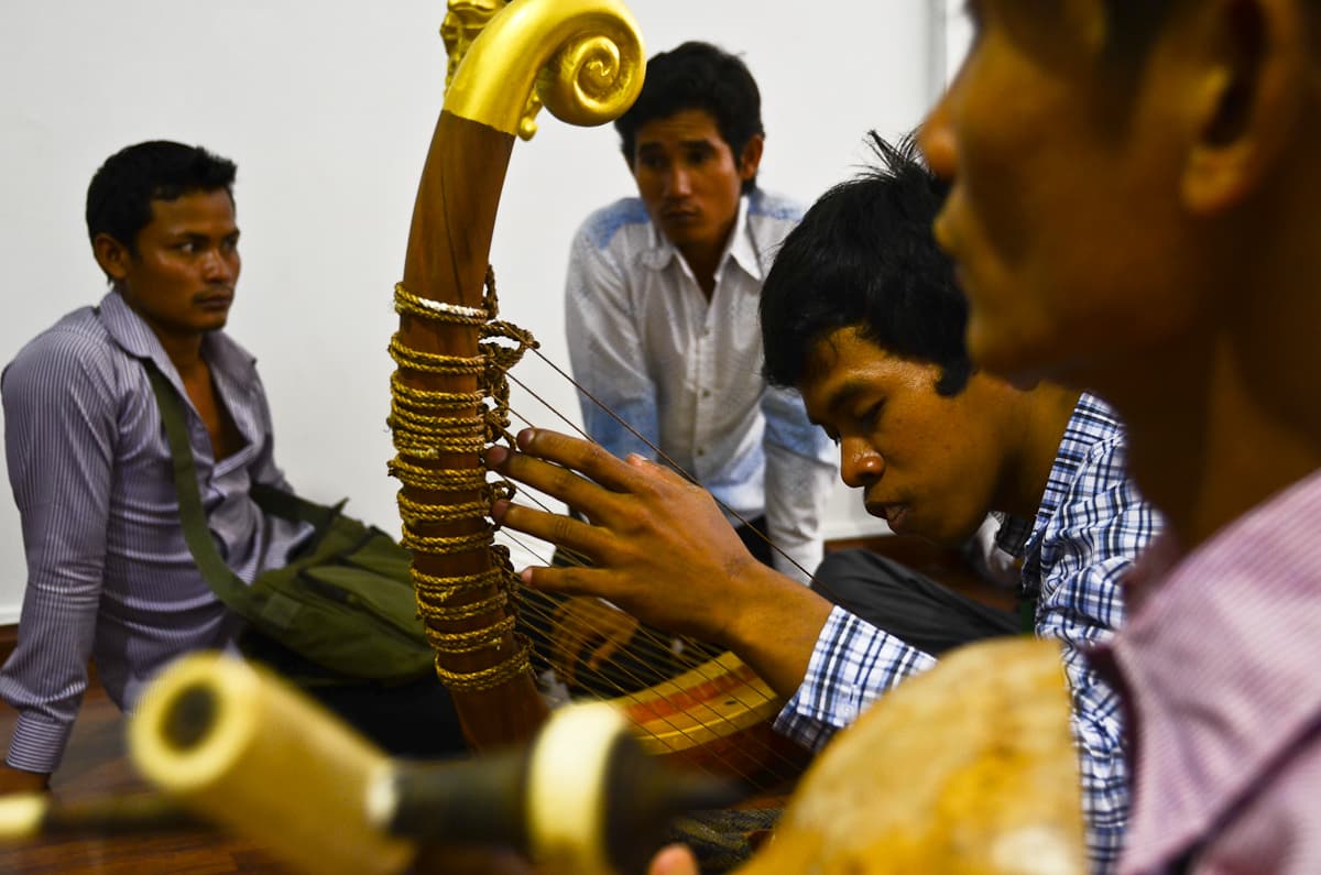 A musician strums the pin, the Cambodian harp, during a rehearsal in Phnom Penh.