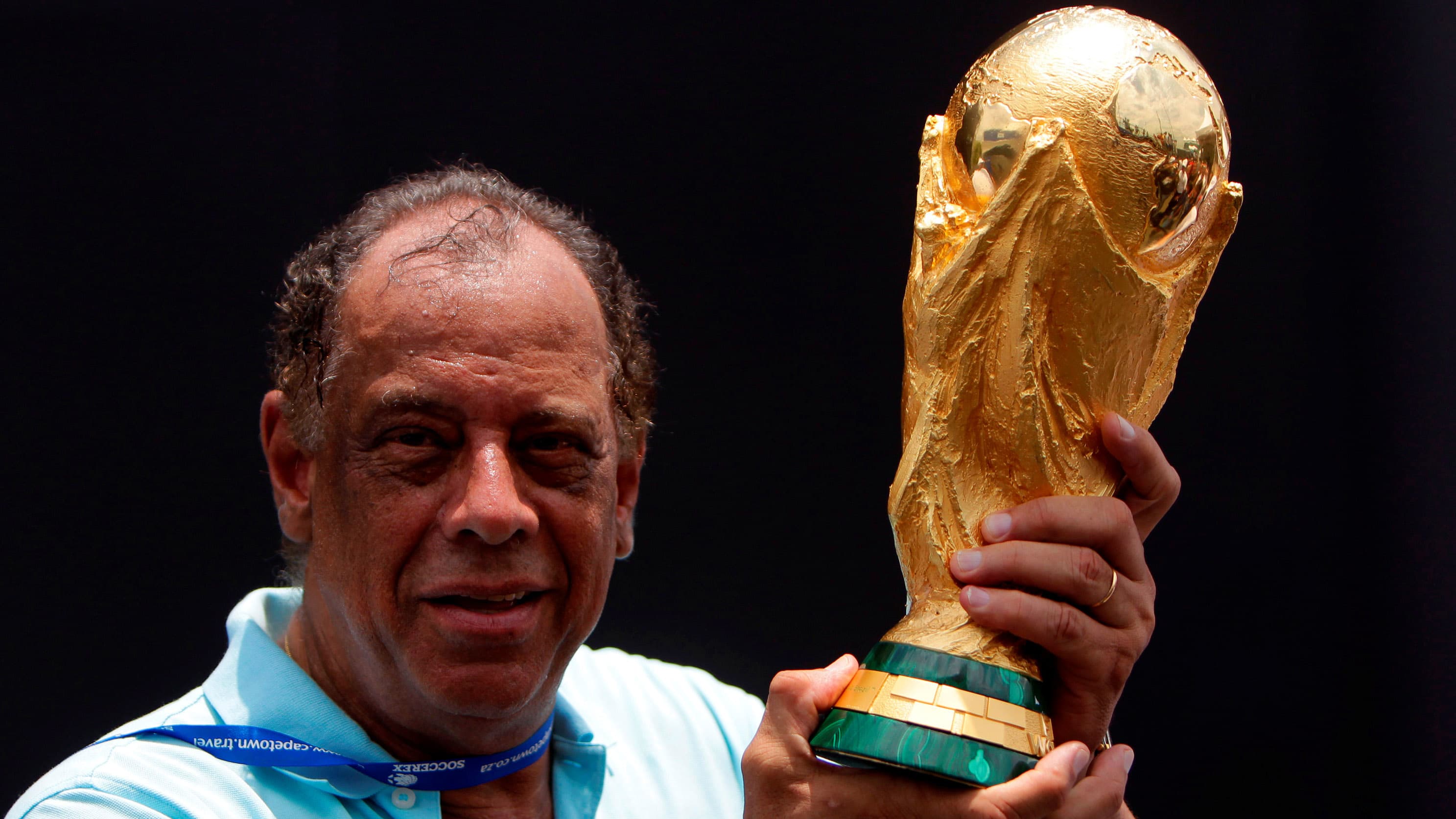 Former Brazilian soccer captain Carlos Alberto Torres holds the FIFA World Cup trophy in Rio de Janeiro on Nov. 21, 2010.