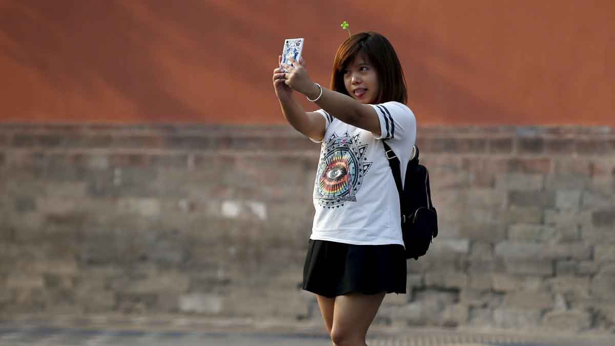 A woman takes a selfie in Beijing, September 2015.