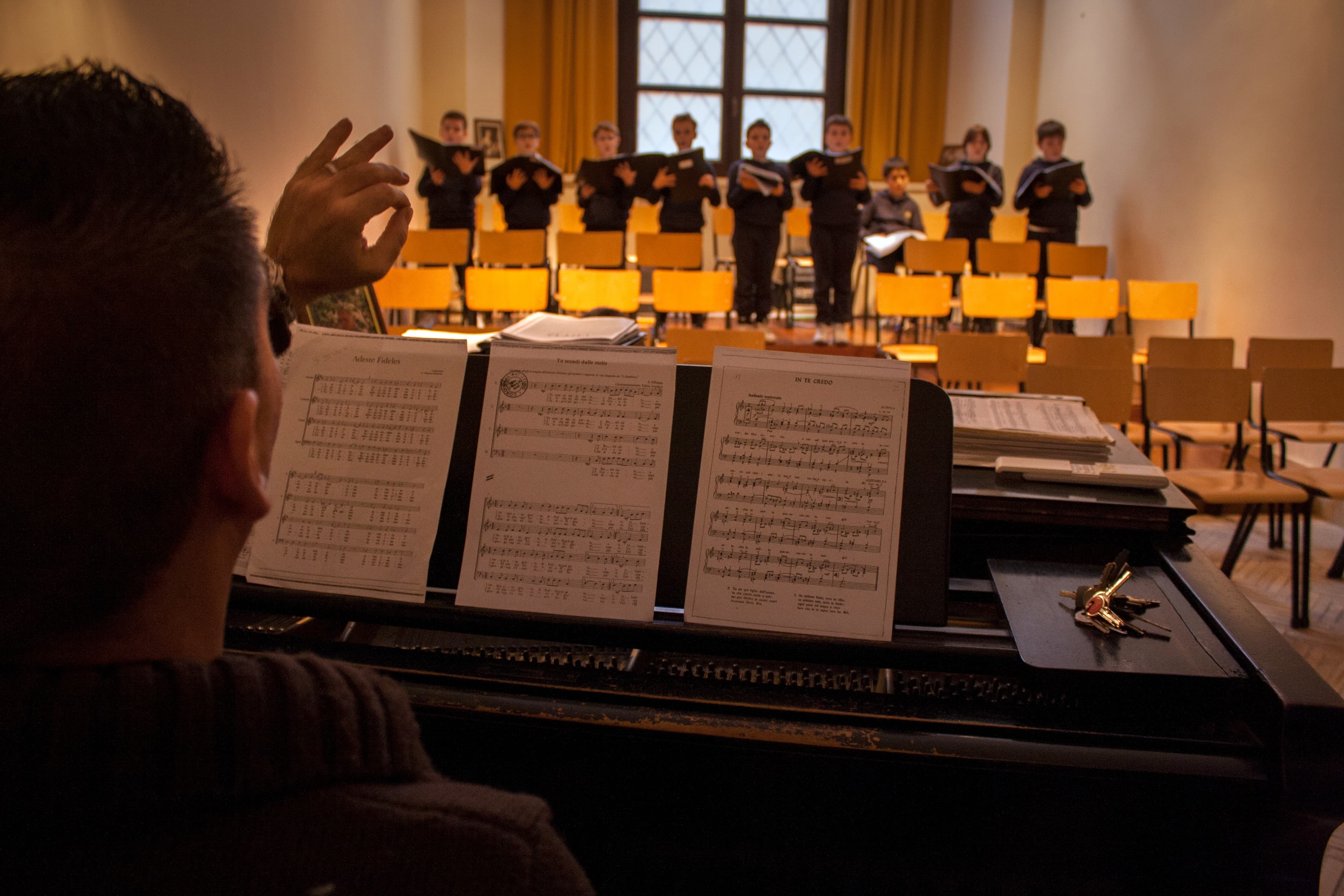 Music teacher Adriano Caroletti coaches 3rd graders during their preparatory year at the Schola Puerorum in Rome.