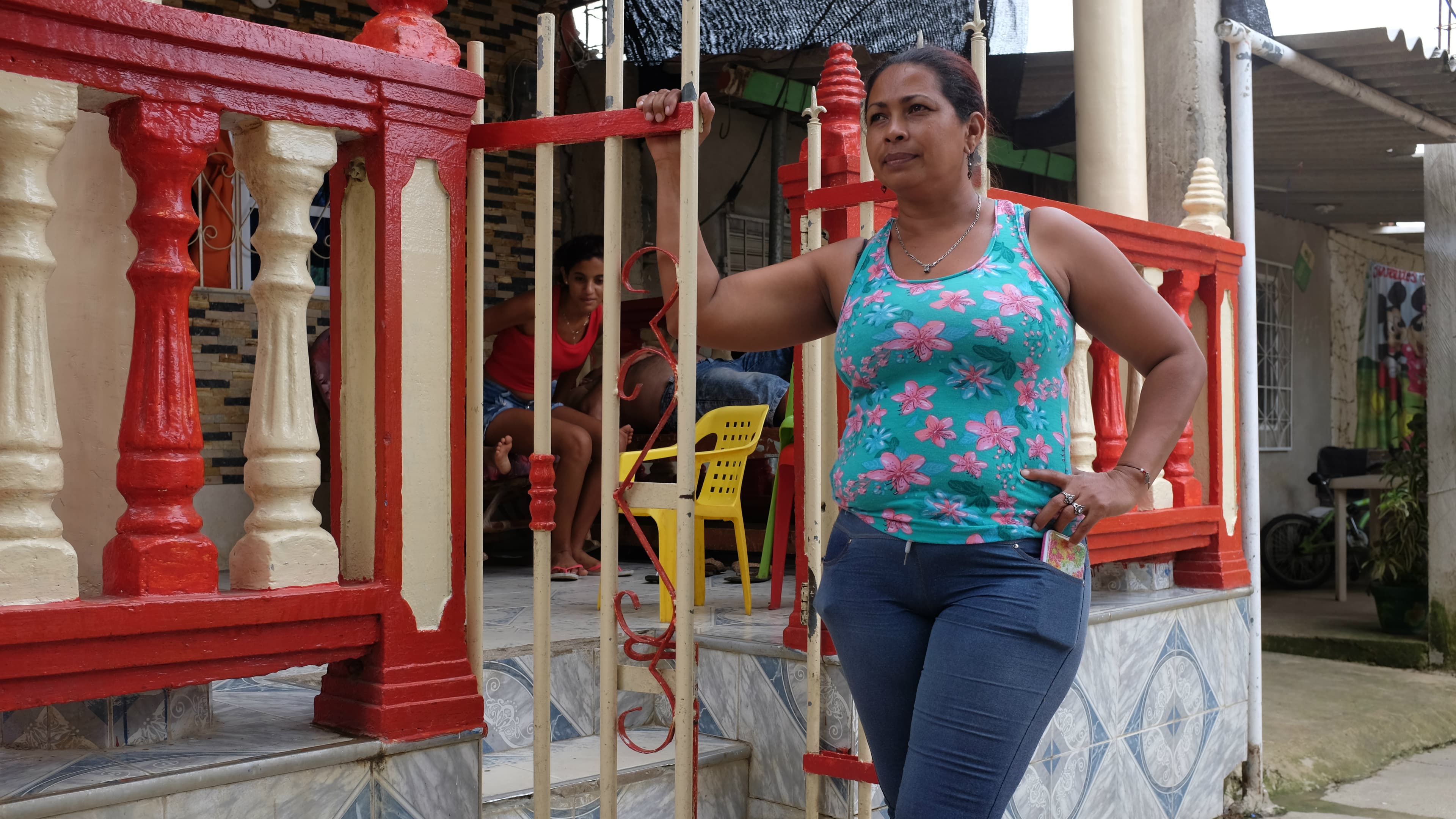Eidanis Lamadrid, a founding member of the City of Women, stands in front of a neighbor's home. “I’m not sure that the peace process will bring peace here,” she said, referring to the Colombian government's peace deal with the FARC rebel group.