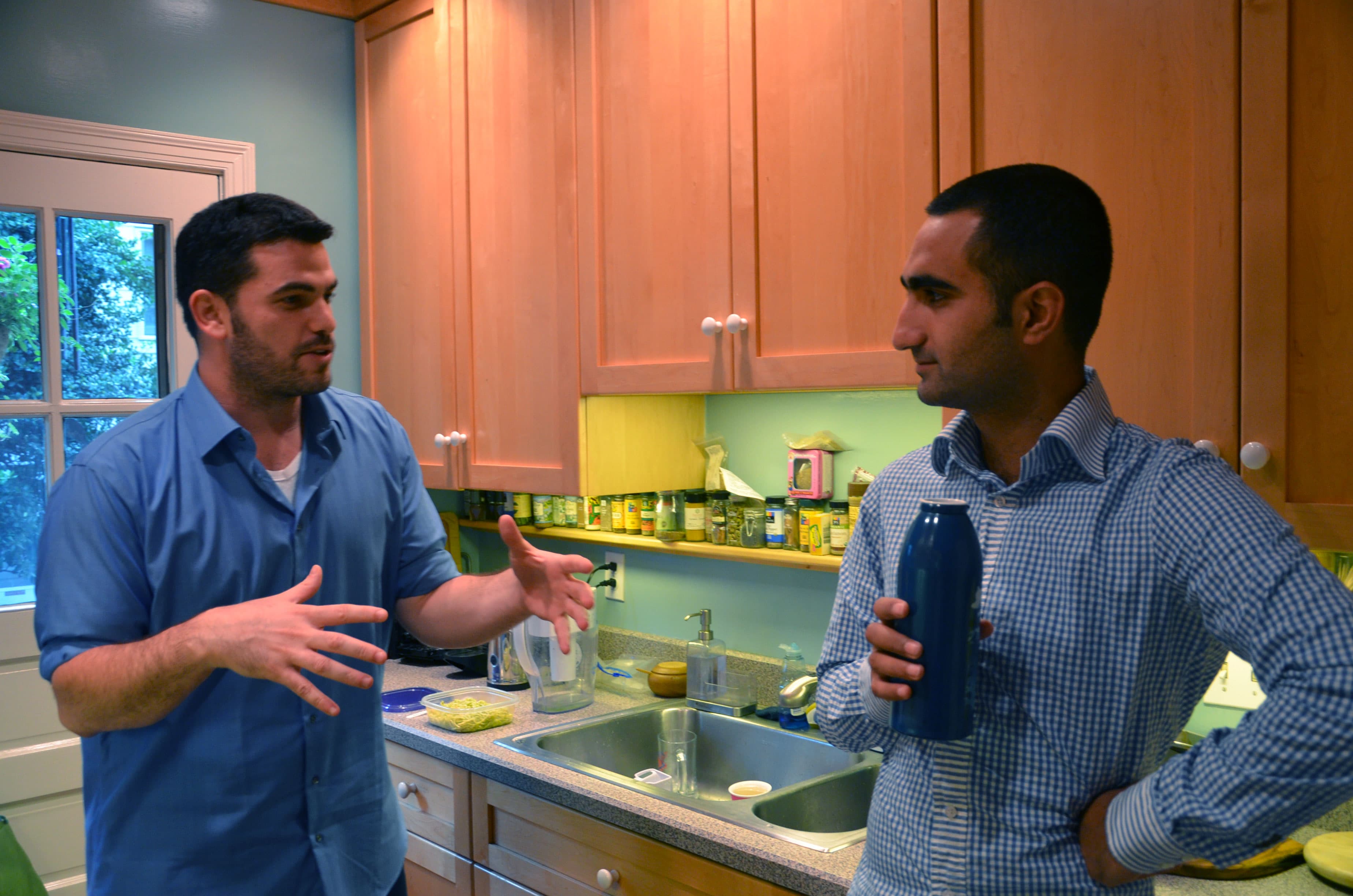 Yehonatan Toker (left) and Hamze Awawde (right) in their kitchen in Washington, DC. Toker, an Israeli, and Awawde, a Palestinian, are in Washington for internships, and they're sharing a house.