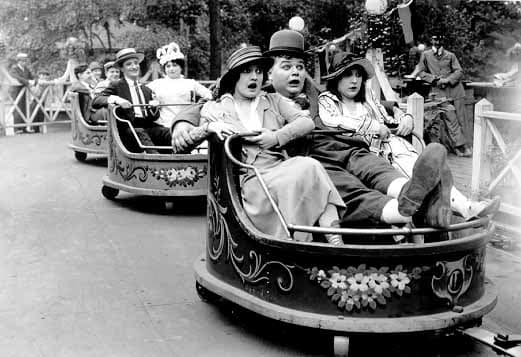 Fatty Arbuckle (center) riding in The Whip, one of William F. Mangels' classic rides. At one time, Mangels had 500 of them in operation.