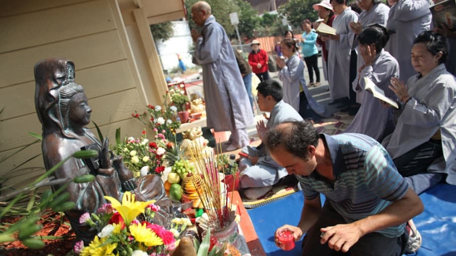 Vietnamese immigrants pray to a small shrine erected five years ago. The area was once littered, covered in graffiti, and a frequent stop for the city's public works department. But after one neighborhood resident placed the statue on the corner, local Vi