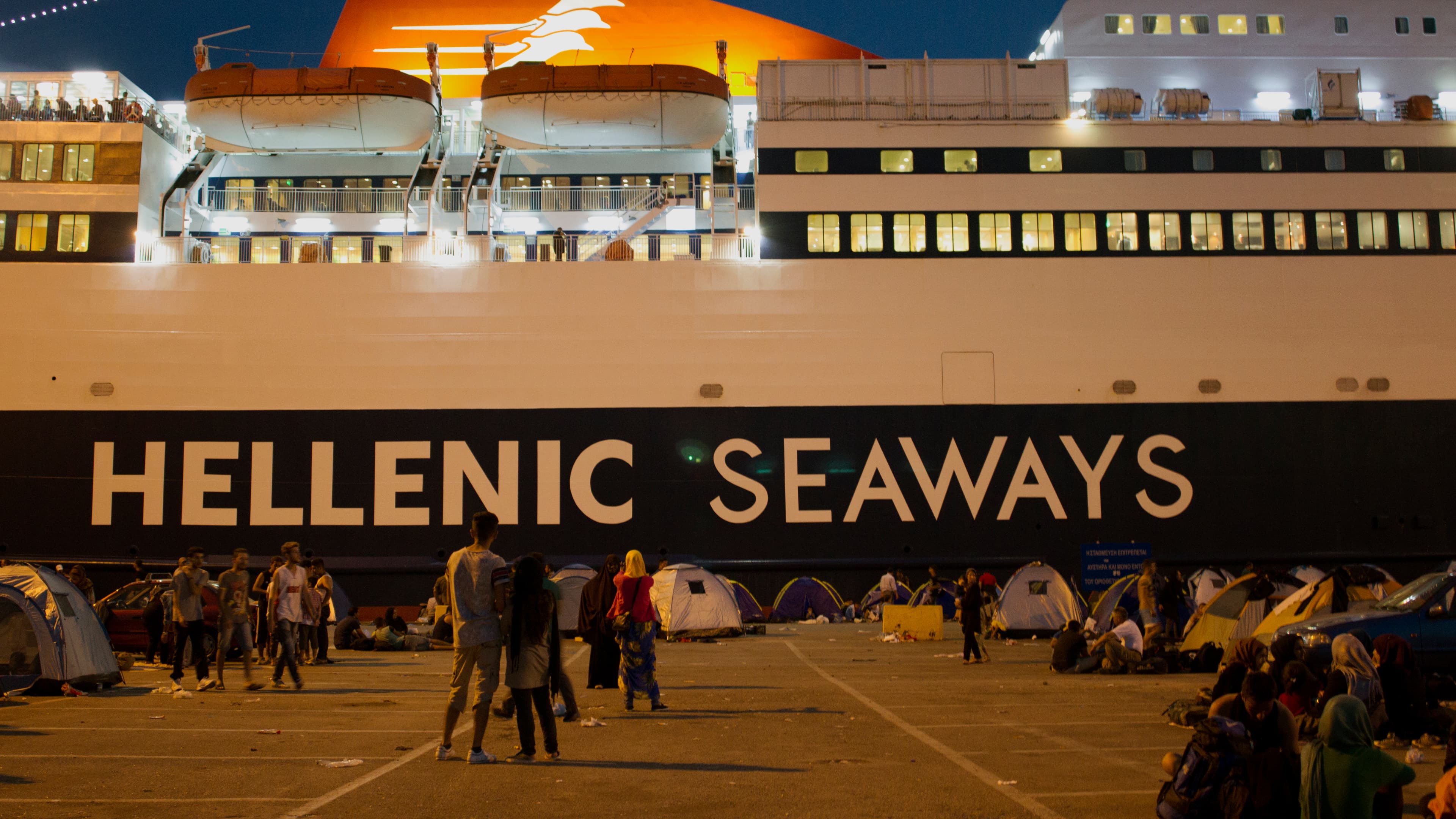 Refugees set up tents at the main port. They're hoping to get tickets for a ferry like this that will take them to Greece.