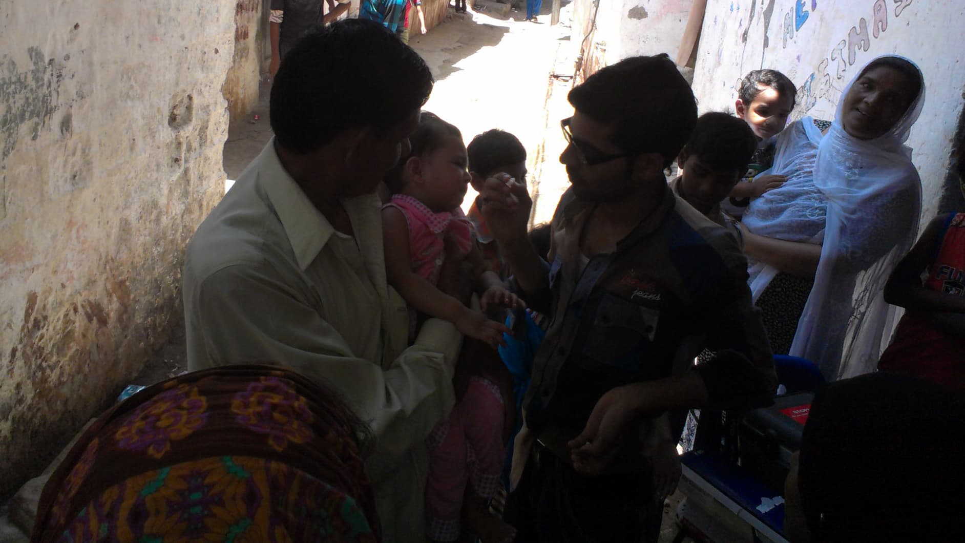 A child is immunized against polio at a makeshift clinic in the poor Karachi neighborhood called Hijrat.