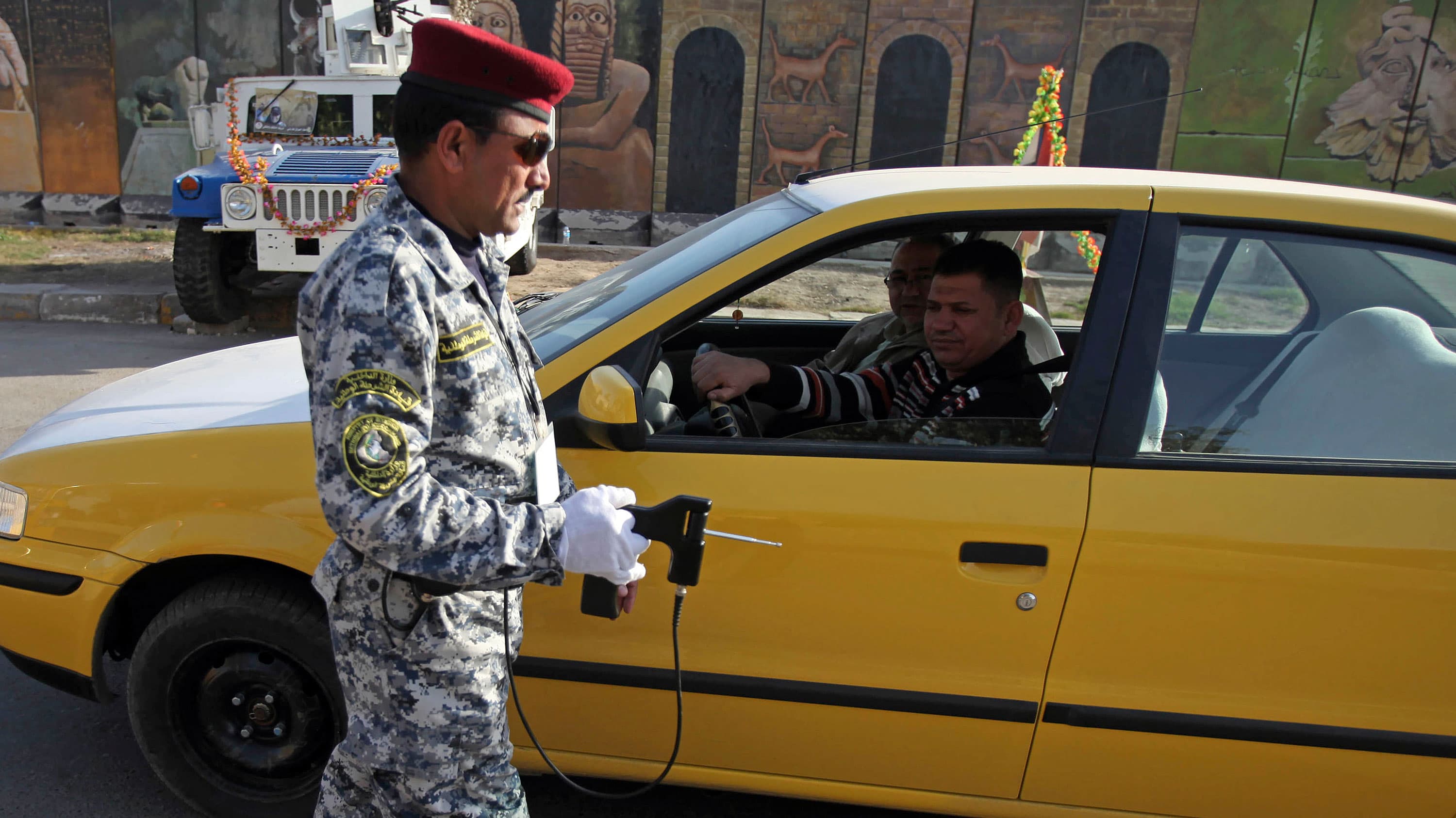 An Iraqi police officer uses the device to inspect a car at checkpoint in central Baghdad, Iraq, 2010.