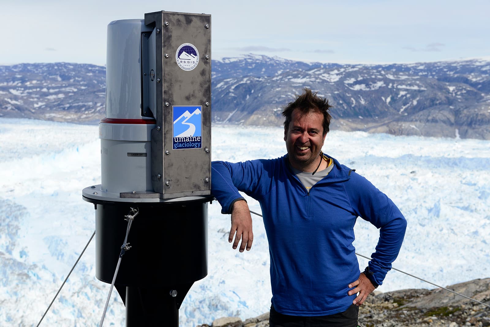 Gordon Hamilton with an automated laser scanning system installed to monitor Helheim Glacier, in Southeast Greenland. July 2015.