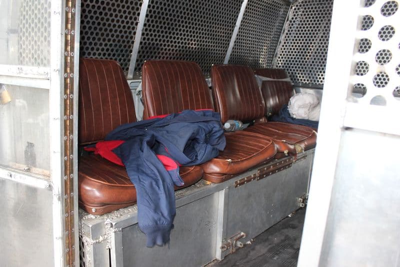 The inside of a private prison transport van.