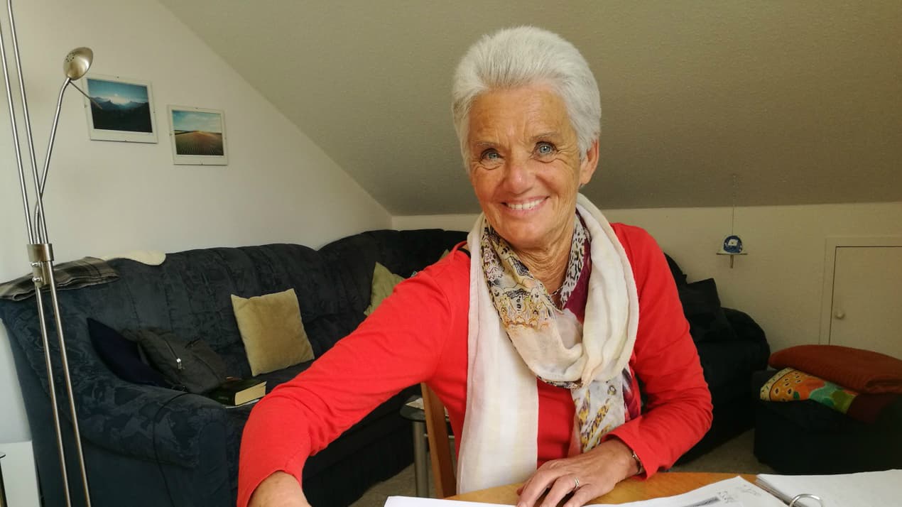 Christa Schmidt at the table in her apartment in Traunreut where she tutors refugees in German. Schmidt’s parents were German refugees from Romania.