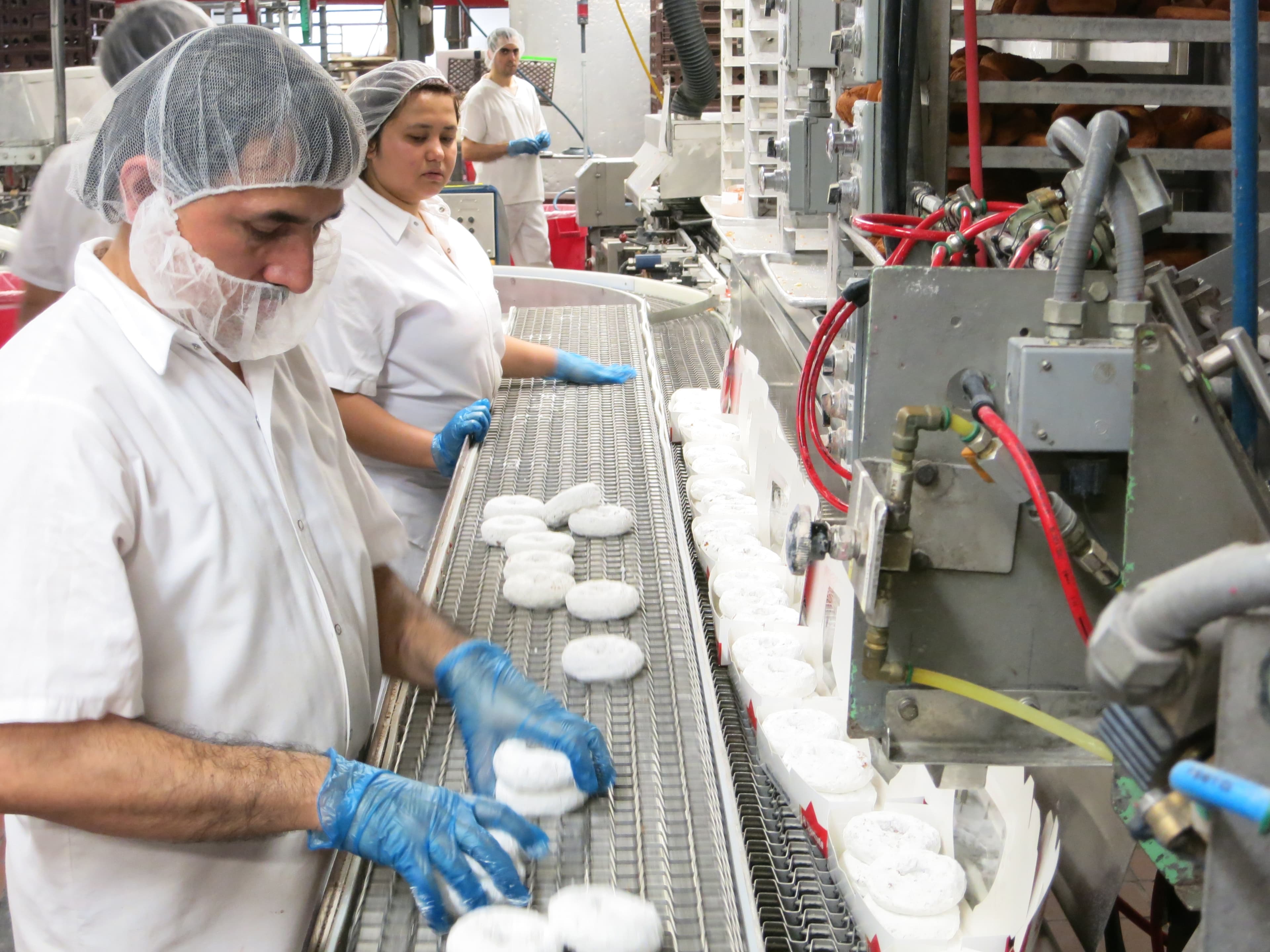 Refugee workers at the Koffee Kup Bakery in Burlington, Vermont package up doughnuts. The human resources manager there says refugees have been instrumental to the company's growth.