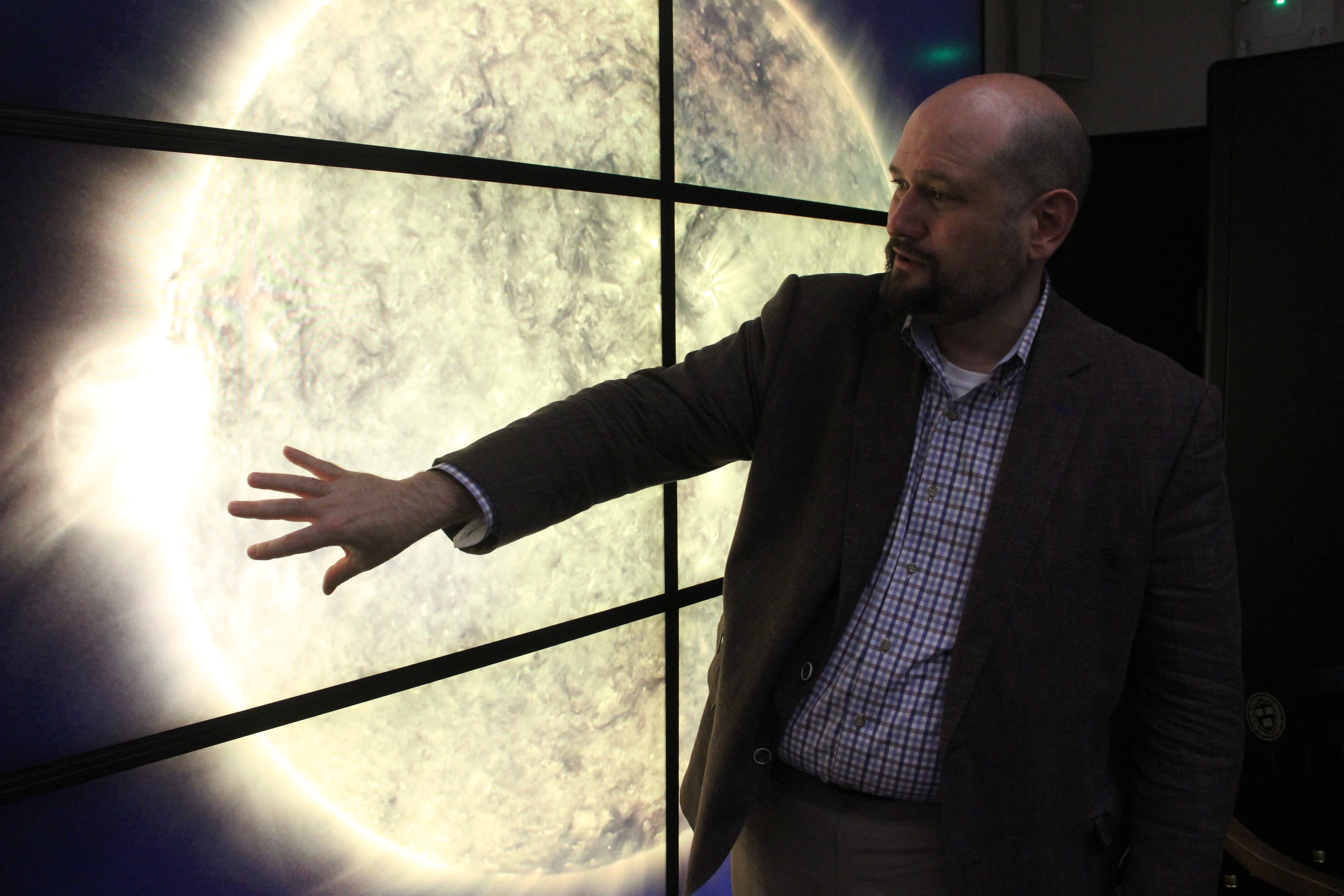 Trae Winter in front of a video screen