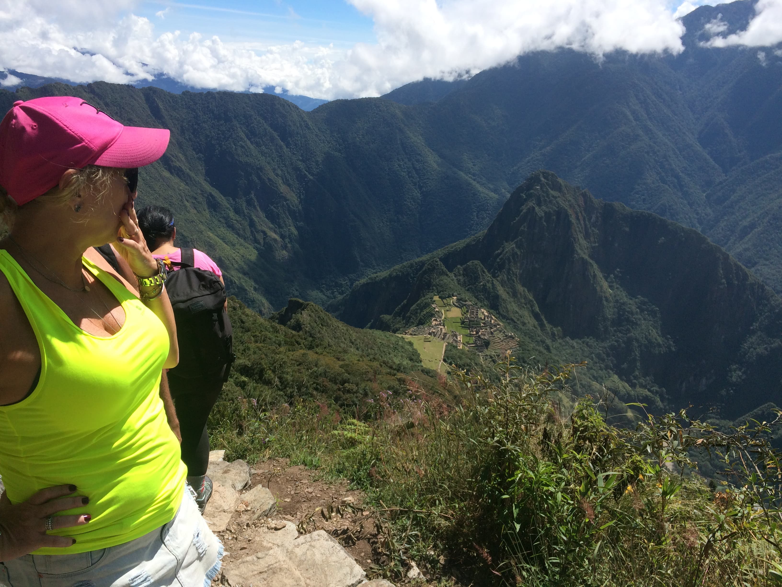 A tourist looks down at the Machu Picchu archeological site in Cuzco, Peru.