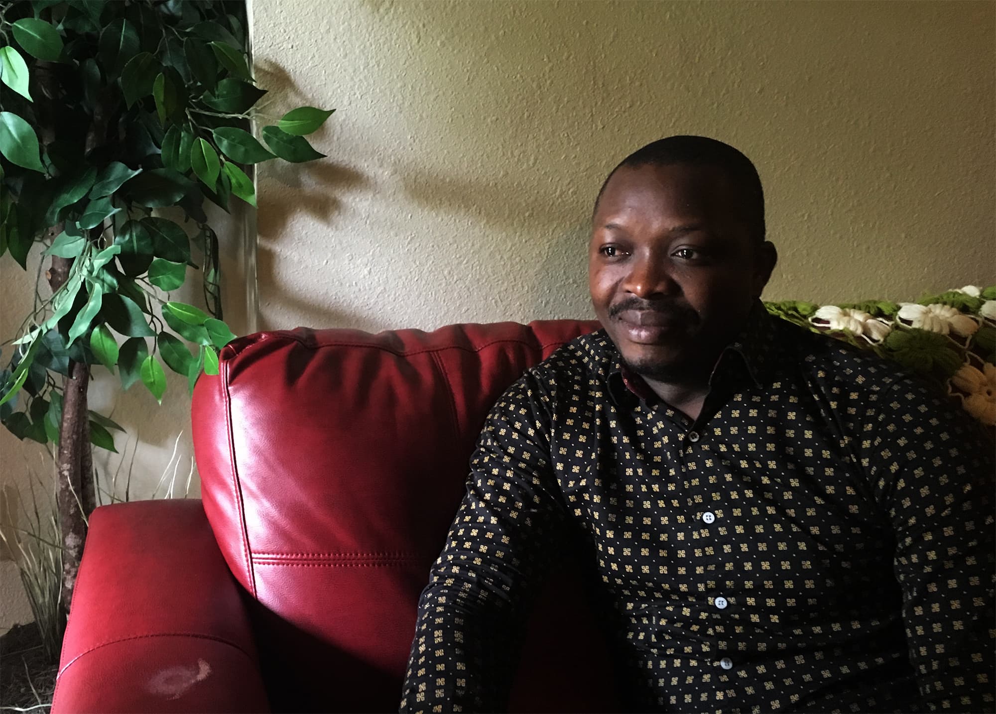 Portrait of man sitting on sofa