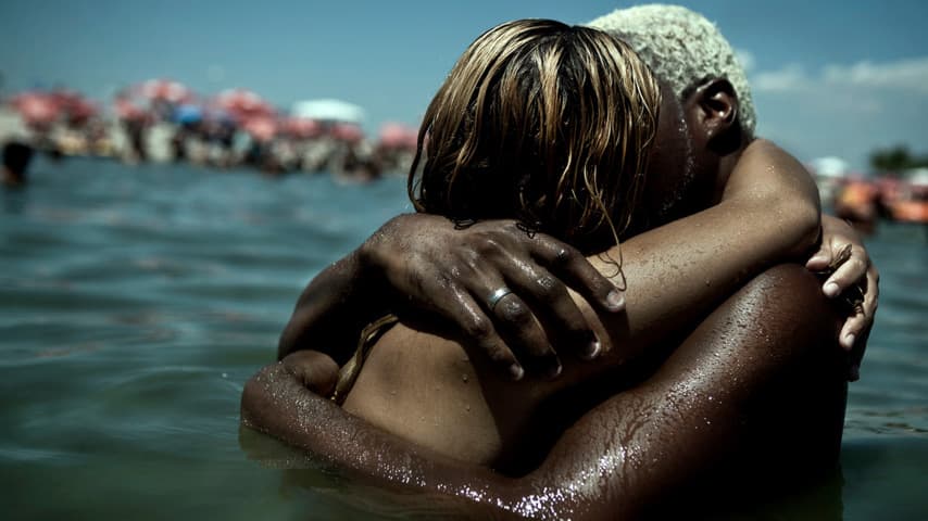 Brazilians embrace at Piscinão de Ramos, an artifical lake next to Guanabara Bay.