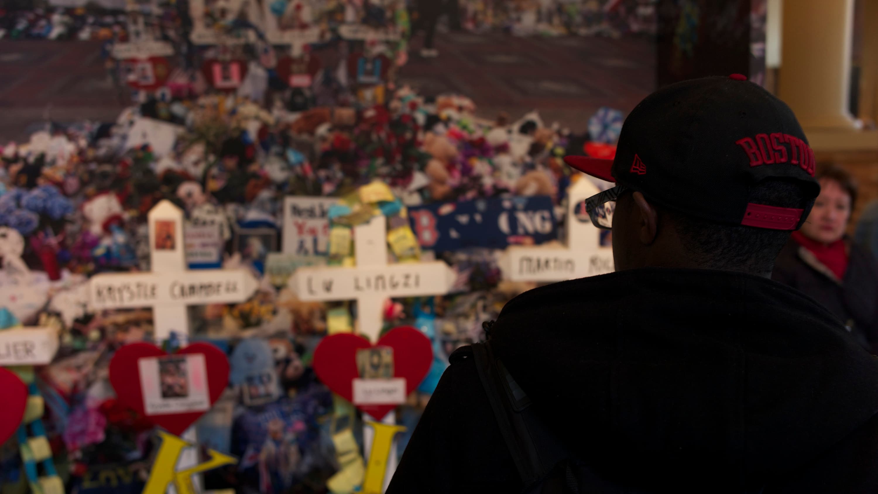 A man looks on at the Dear Boston exhibit at the Boston Public Library.