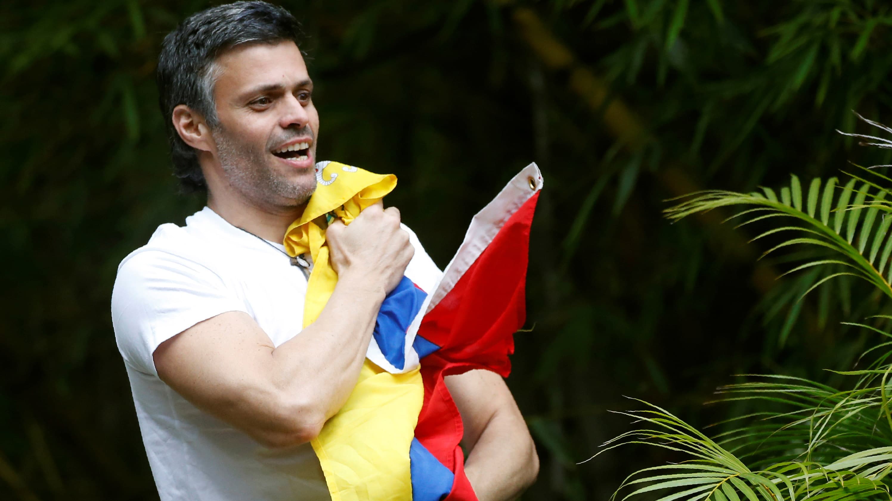Venezuela's opposition leader Leopoldo López, who has been granted house arrest after more than three years in jail, salutes supporters, in Caracas, Venezuela