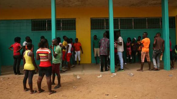 Students talk and catch up at Matilda Newport Junior High School, a public school, on the first day of registration for classes in Monrovia.