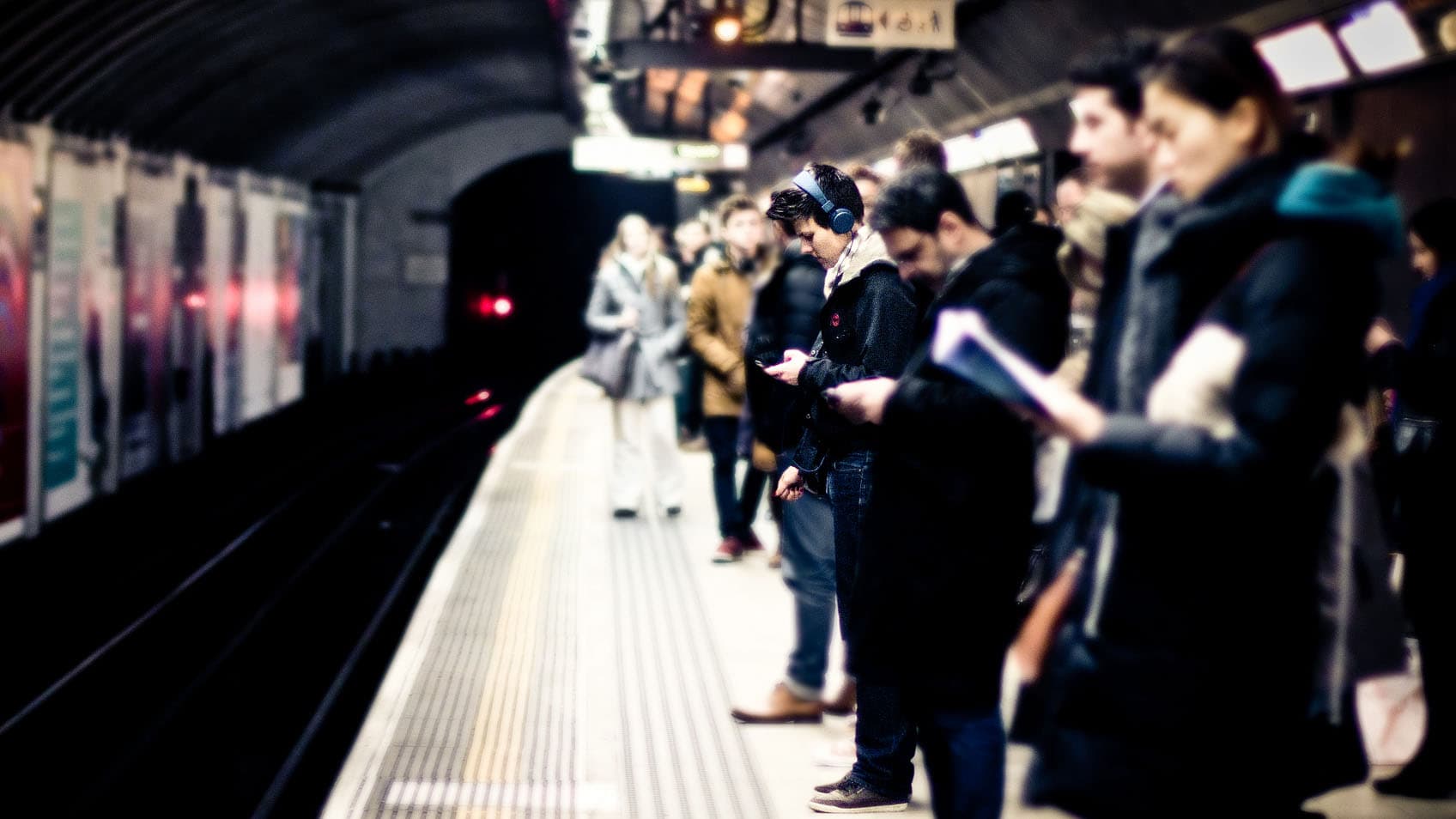 People waiting in a London Underground station.