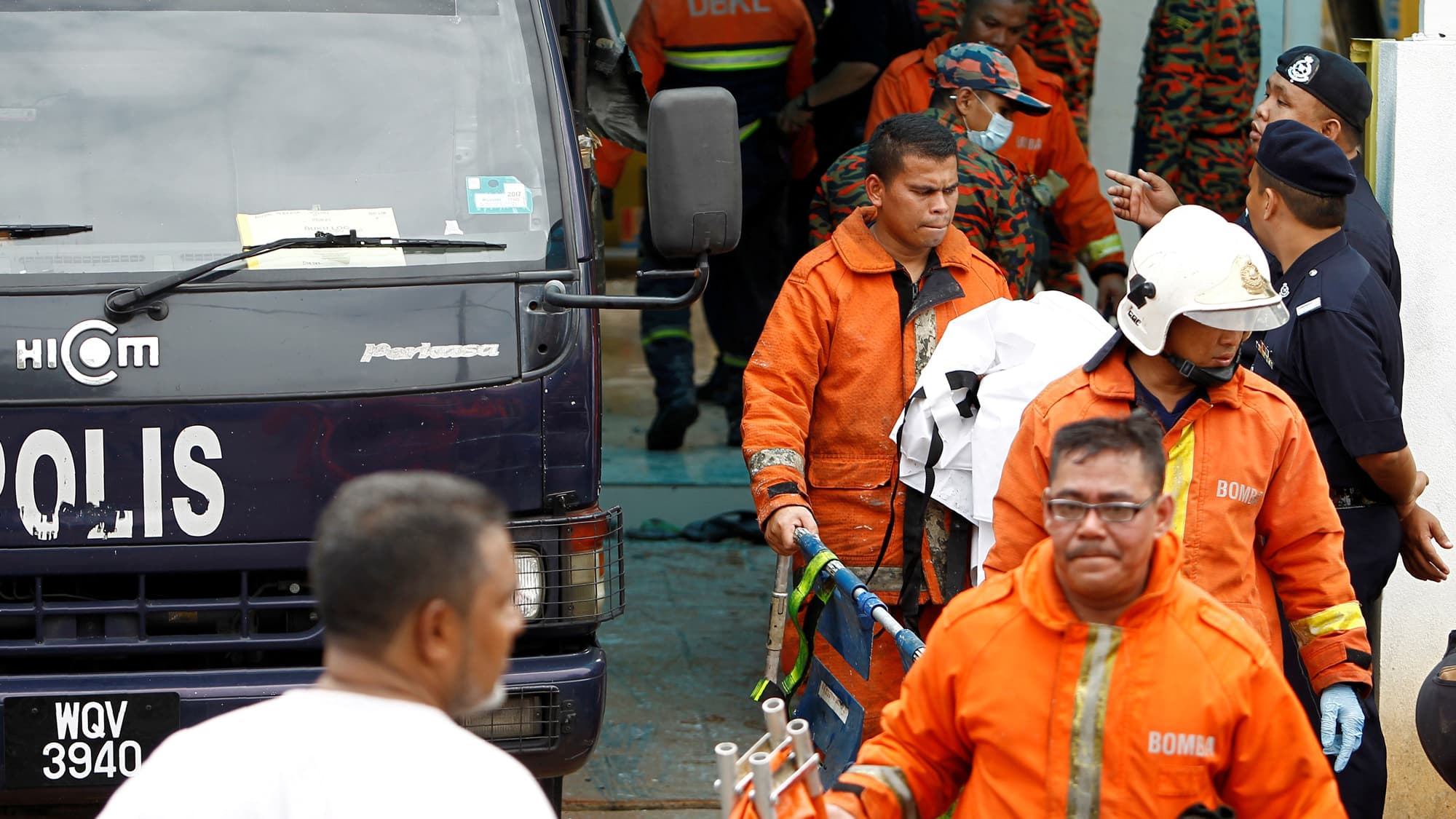 Firefighters leave religious school Darul Quran Ittifaqiyah after a fire broke out in Kuala Lumpur, Malaysia.