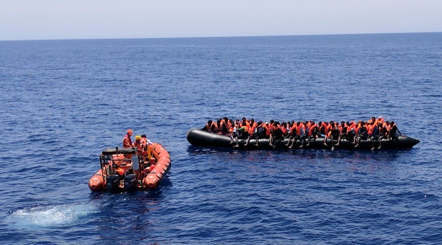 Save the Children workers rescue migrants on a boat in the Mediterranean off the coast of Libya
