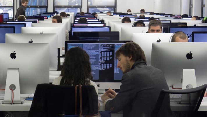 More than a thousand Macintosh computer screens light up 42's open work spaces where students are given assignments.