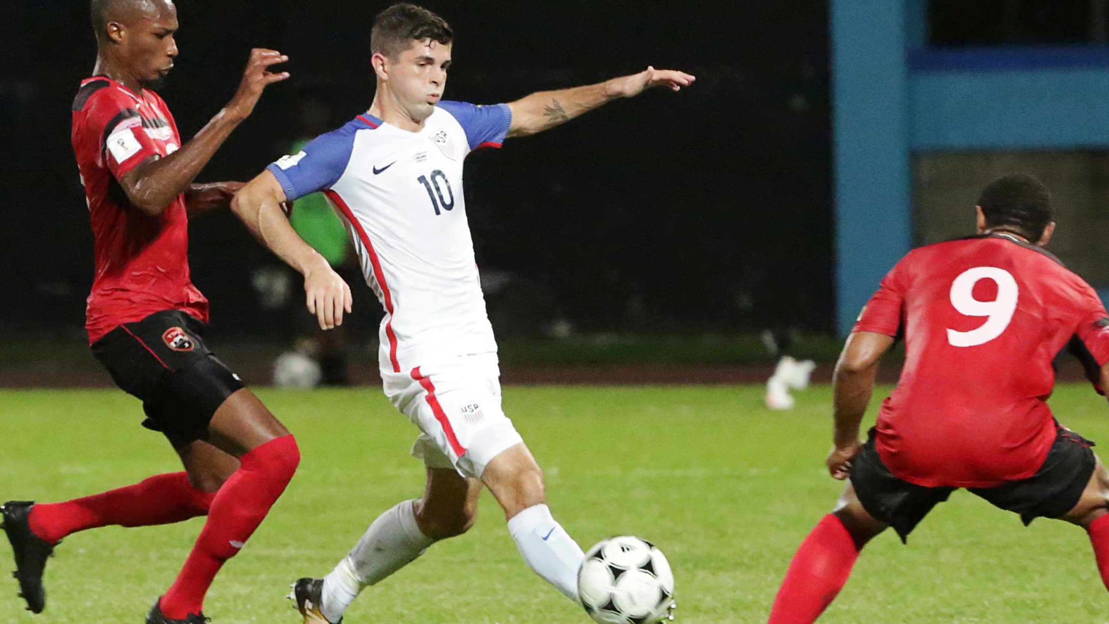 United States' Christian Pulisic and Trinidad's Kevan George and Shahdon Winchester in action.