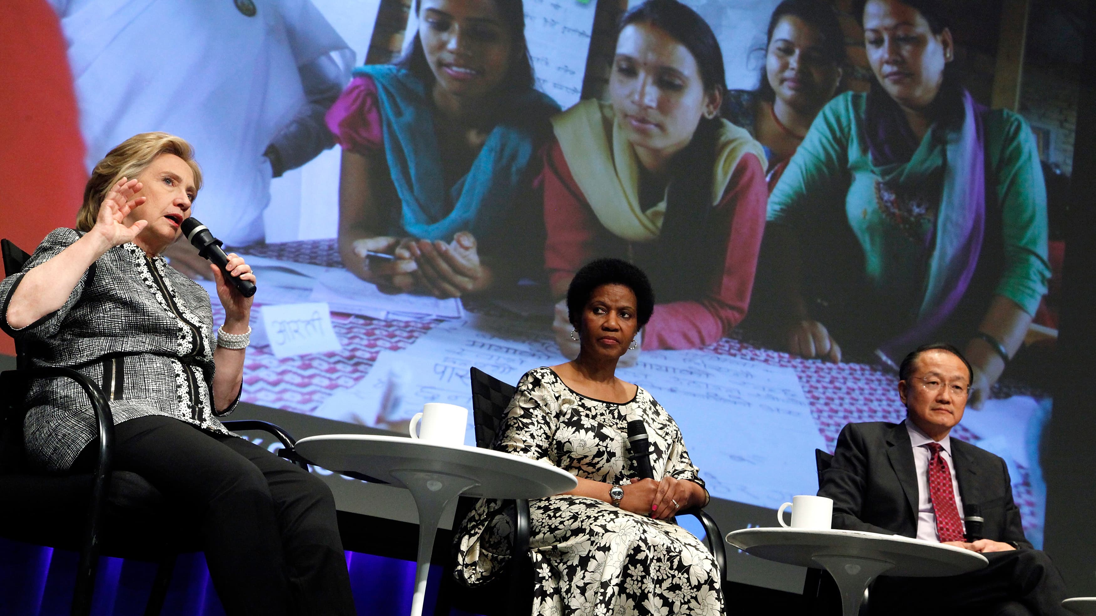 UN Women Executive Director Phumzile Mlambo-Ngcuka (C), former US Secretary of State Hillary Clinton (L) and World Bank Group President Jim Yong Kim (R) participate in an event on empowering woman and girls, at the World Bank.