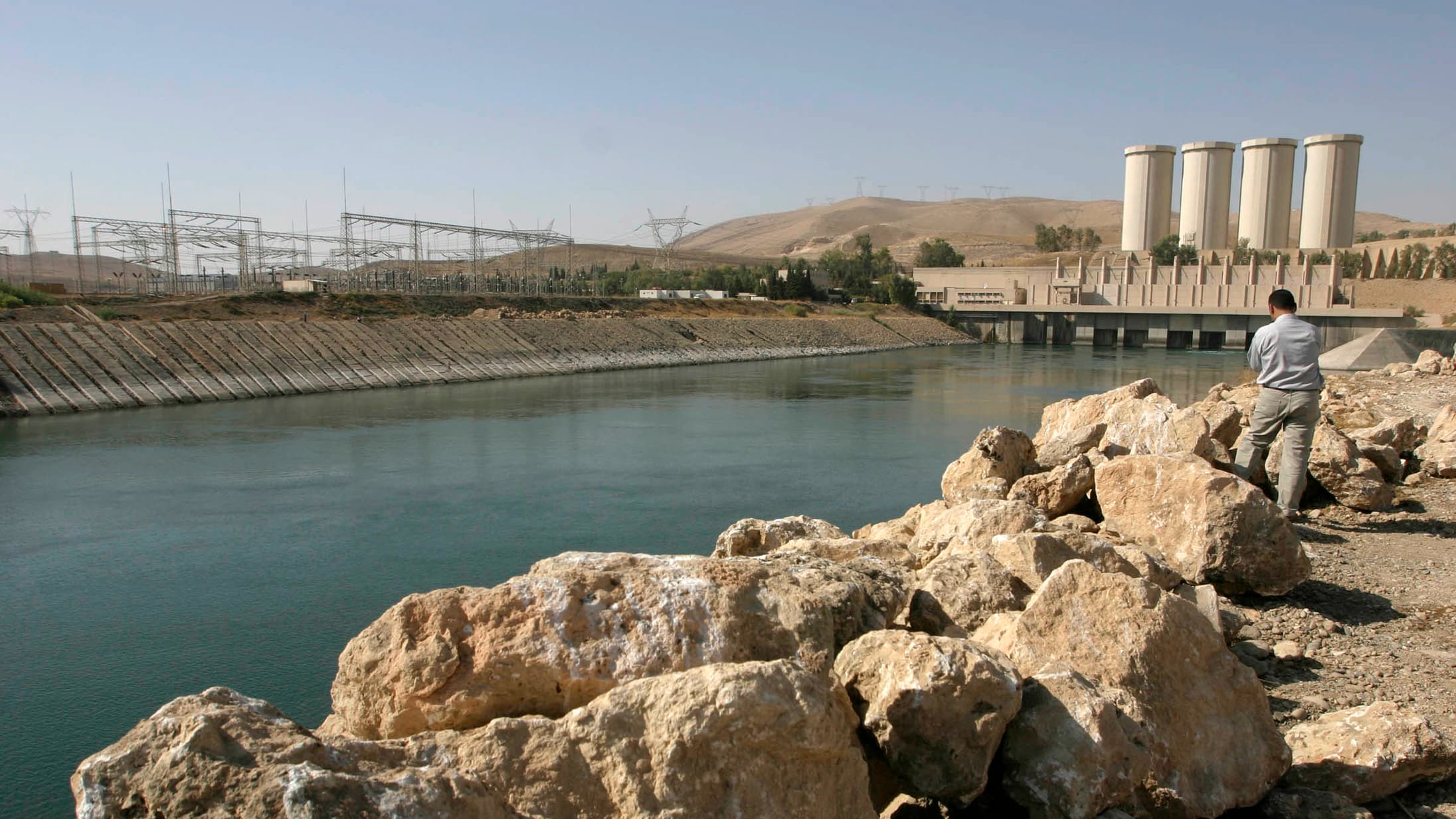 A man stands on the banks of the Mosul Dam on the Tigris River in Mosul, 390 km (240 miles) northwest of Baghdad on November 1, 2007.