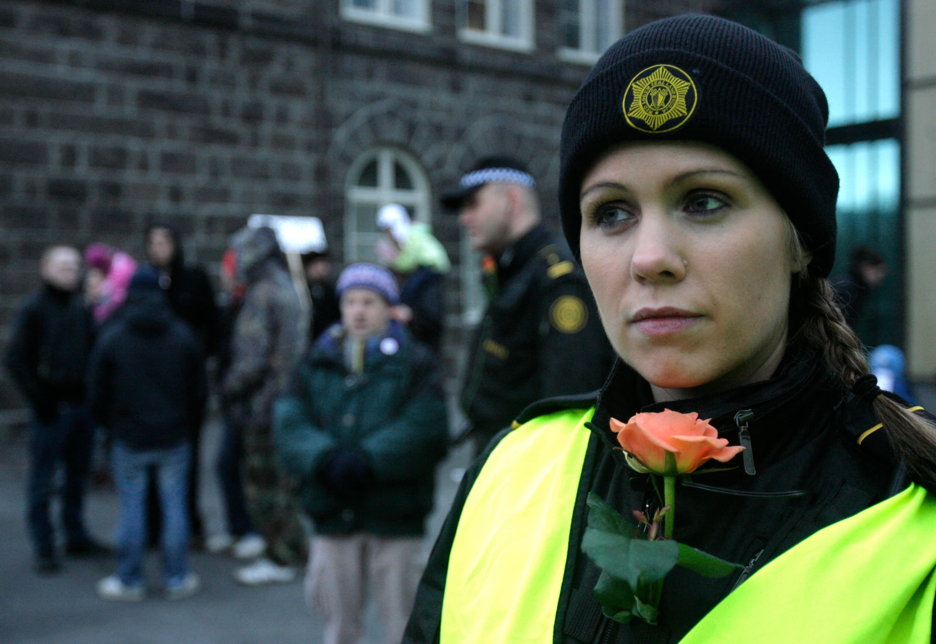 An Icelandic police officer stands guard at a peaceful protest near Iceland's Parliament house in Reykjavik