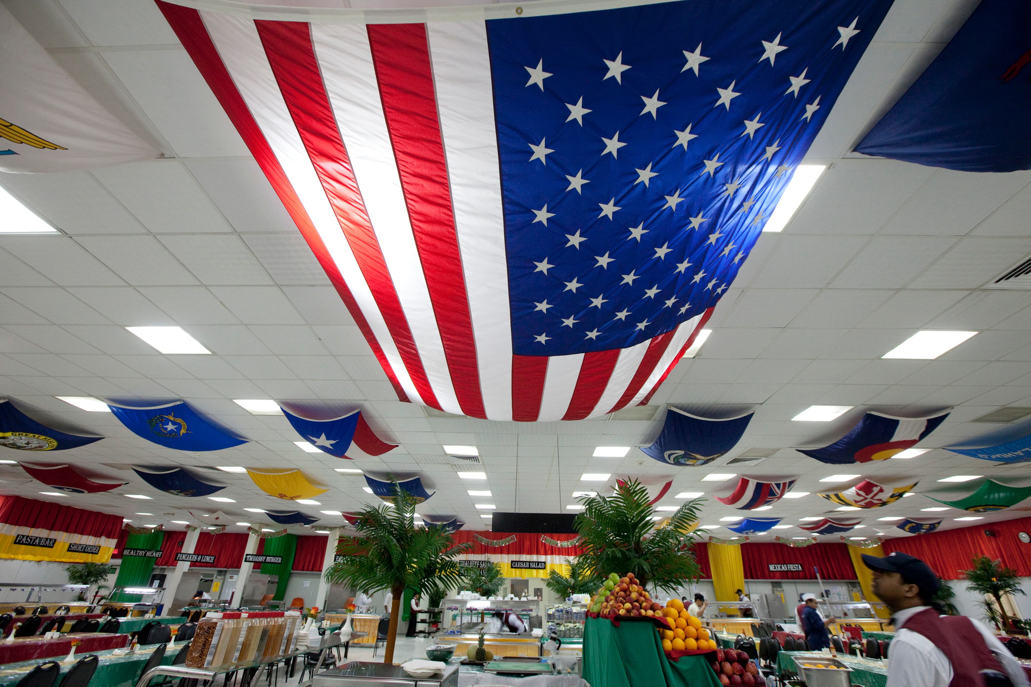 A U.S. flag hangs over fake palm trees inside the compound of the U.S. embassy in Baghdad in 2011.