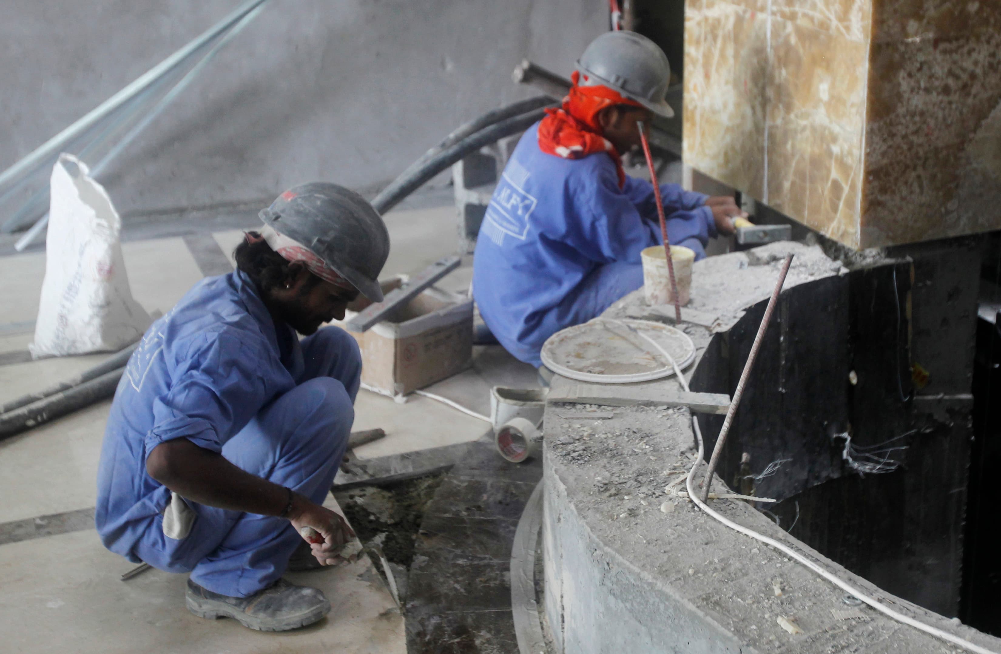 Labourers work at a construction site in Doha June 18, 2012.