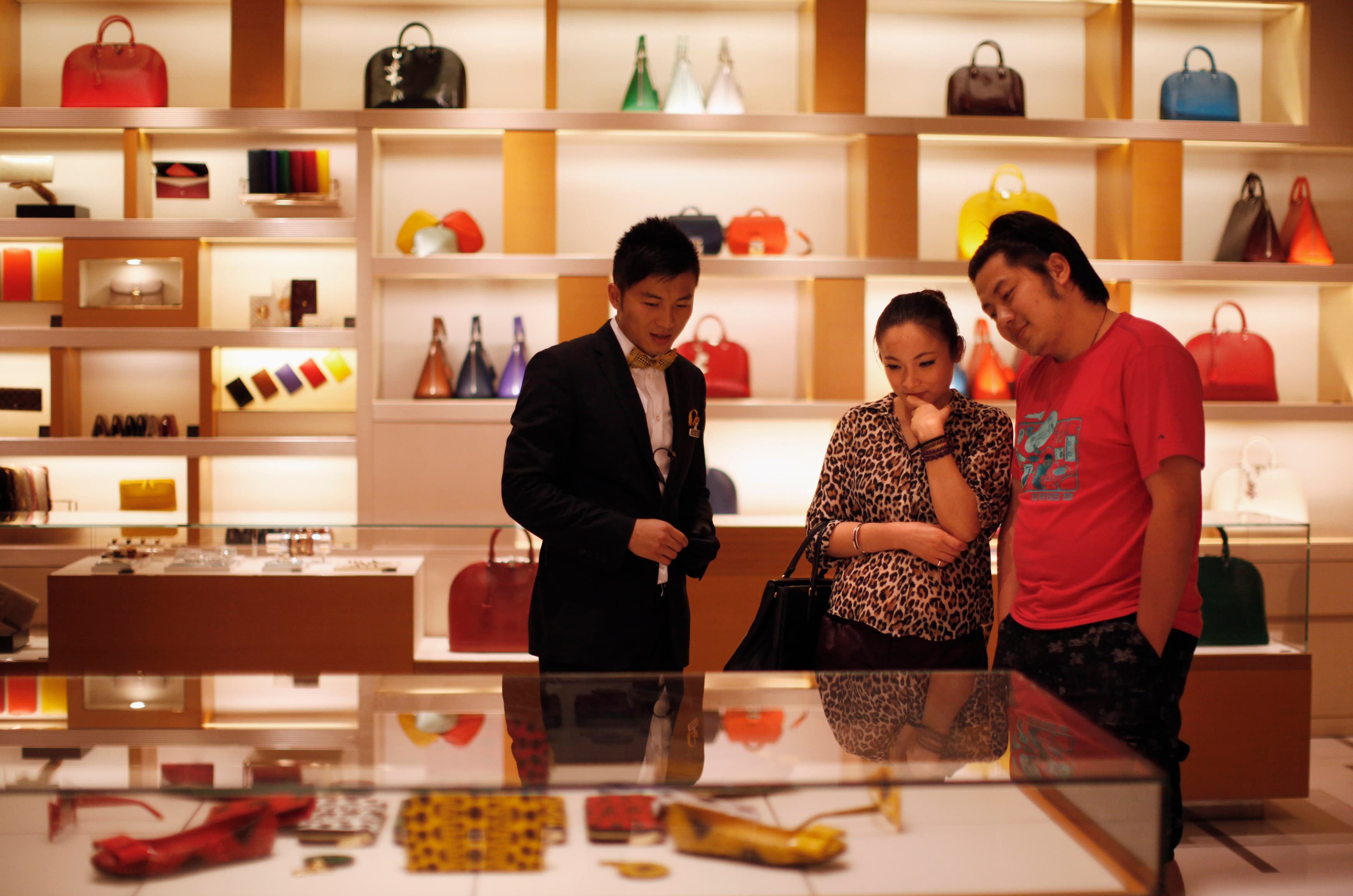 A couple shops at a Louis Vuitton store in China.