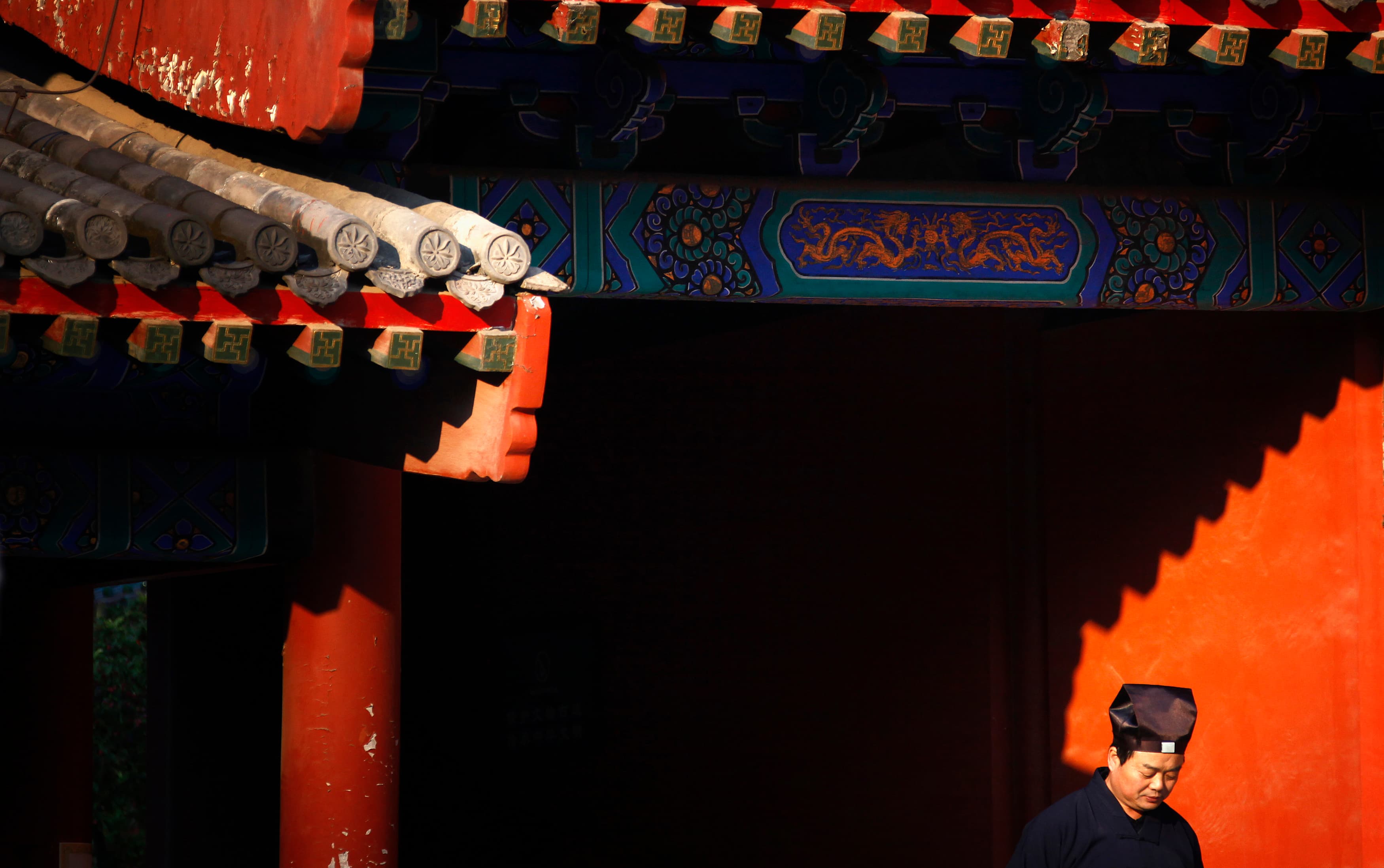 A Taoist priest stands in sunlight to keep warm in the courtyard of the 700-year-old Dongyue Temple in central Beijing.