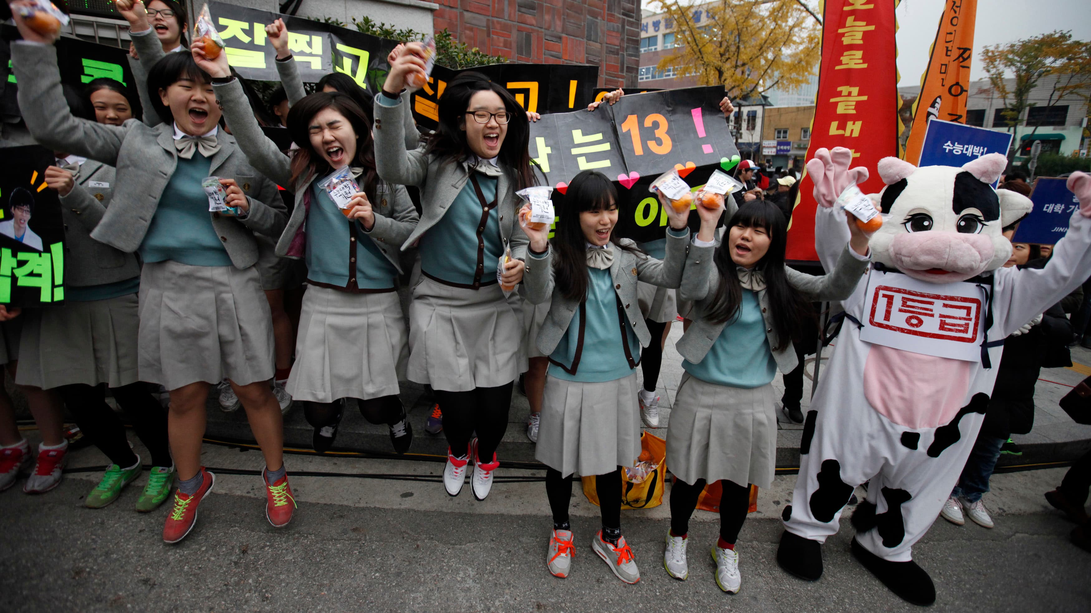 Students from a high school cheer for their seniors in front of a college entrance examination hall before the exam begins in Seoul, South Korea.