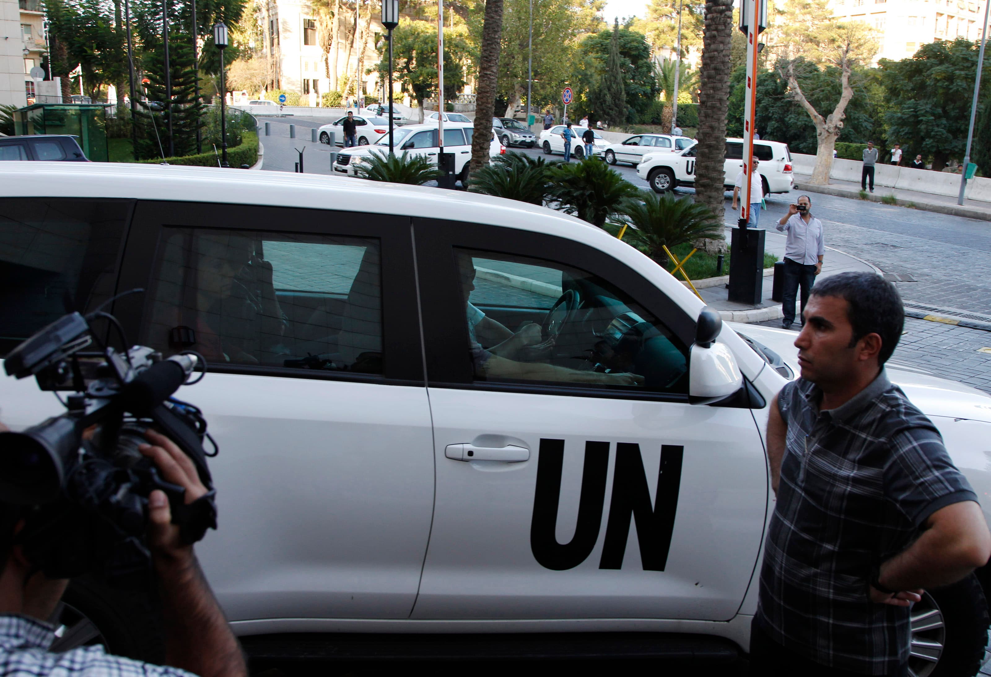 A U.N. convoy transporting a team of United Nations experts charged with starting the process of verifying and eliminating chemical weapons arrives at a hotel in Damascus on October 1, 2013.