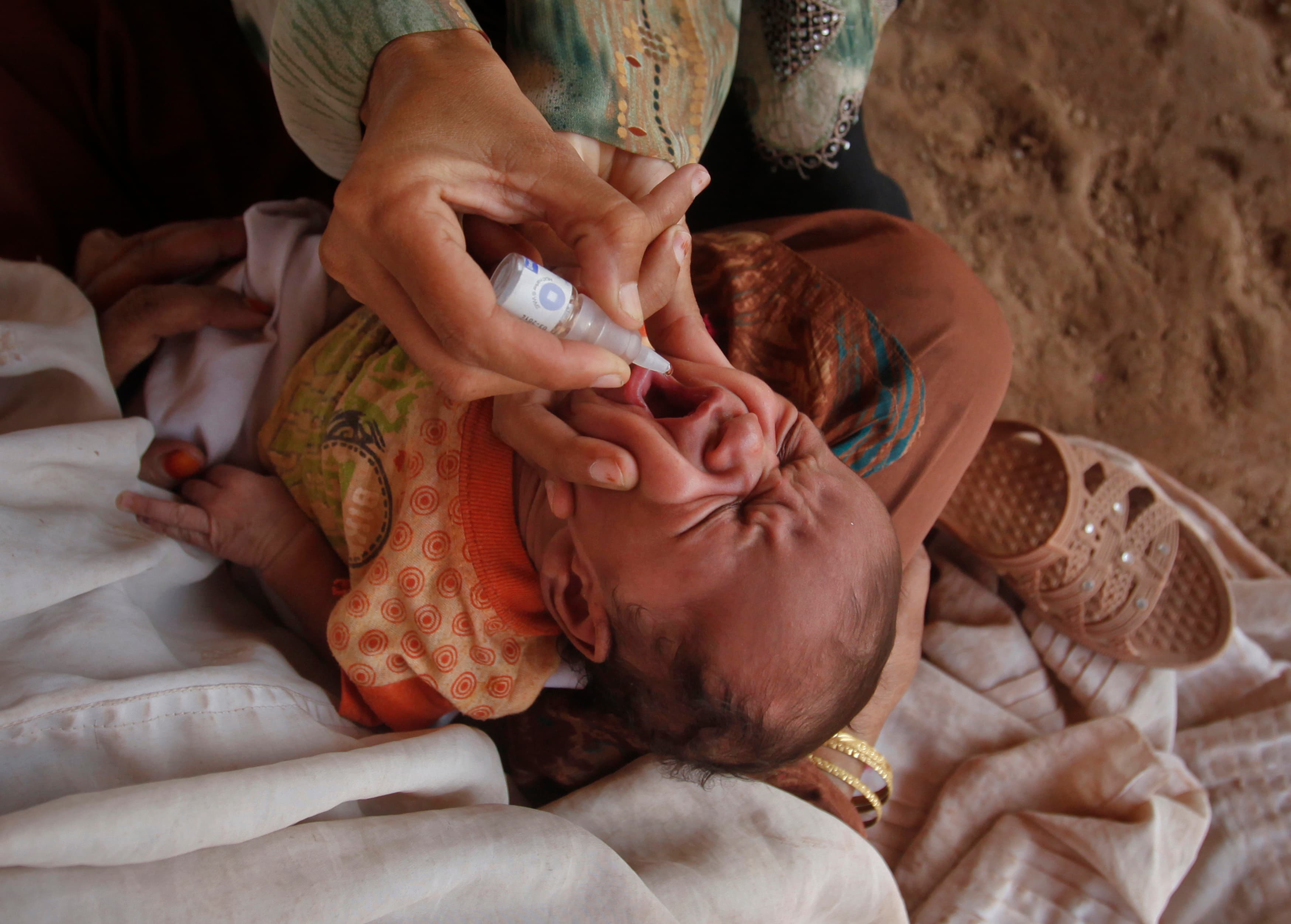A polio worker gives polio vaccine drops to a child in Islamabad. Pakistan is also the only polio-endemic country in the world where polio cases rose from 2012 to 2013.