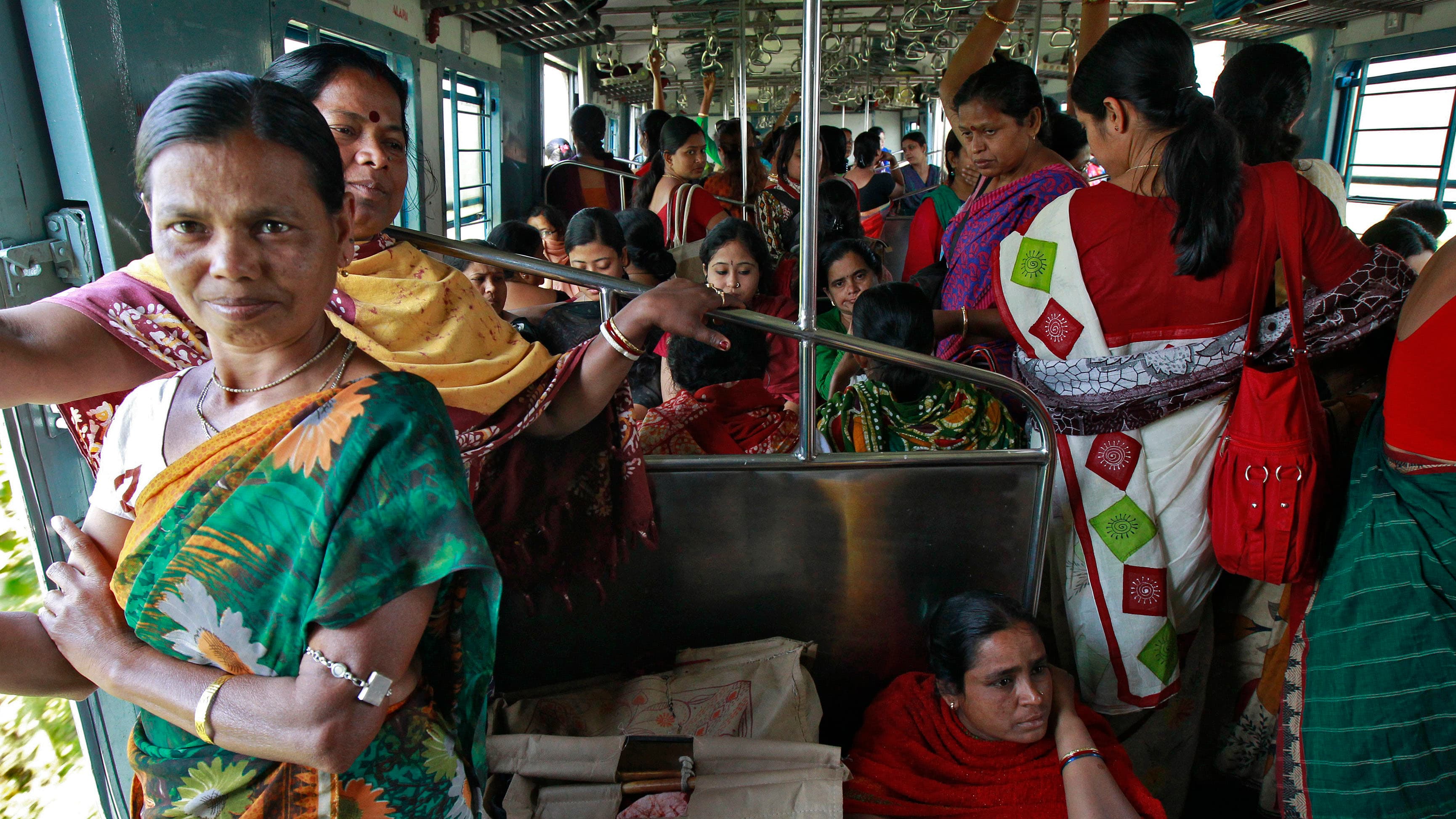 Female passengers travel in the crowded ladies' compartment of a local train in Kolkata, India.